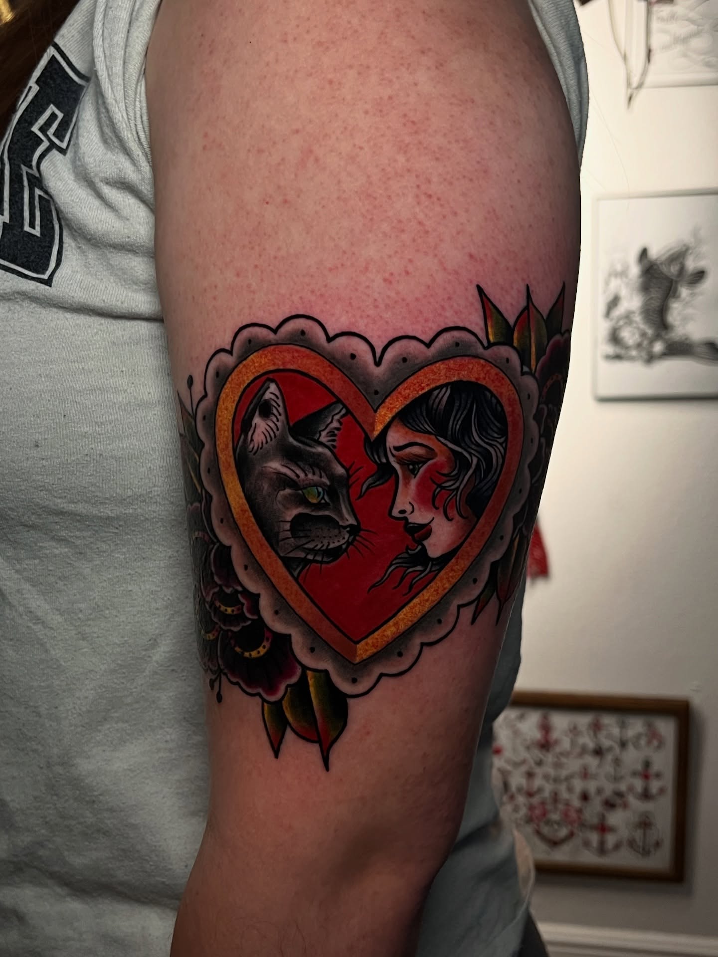 Heart with cat and woman American traditional tattoo on the forearm by Raul Ortiz