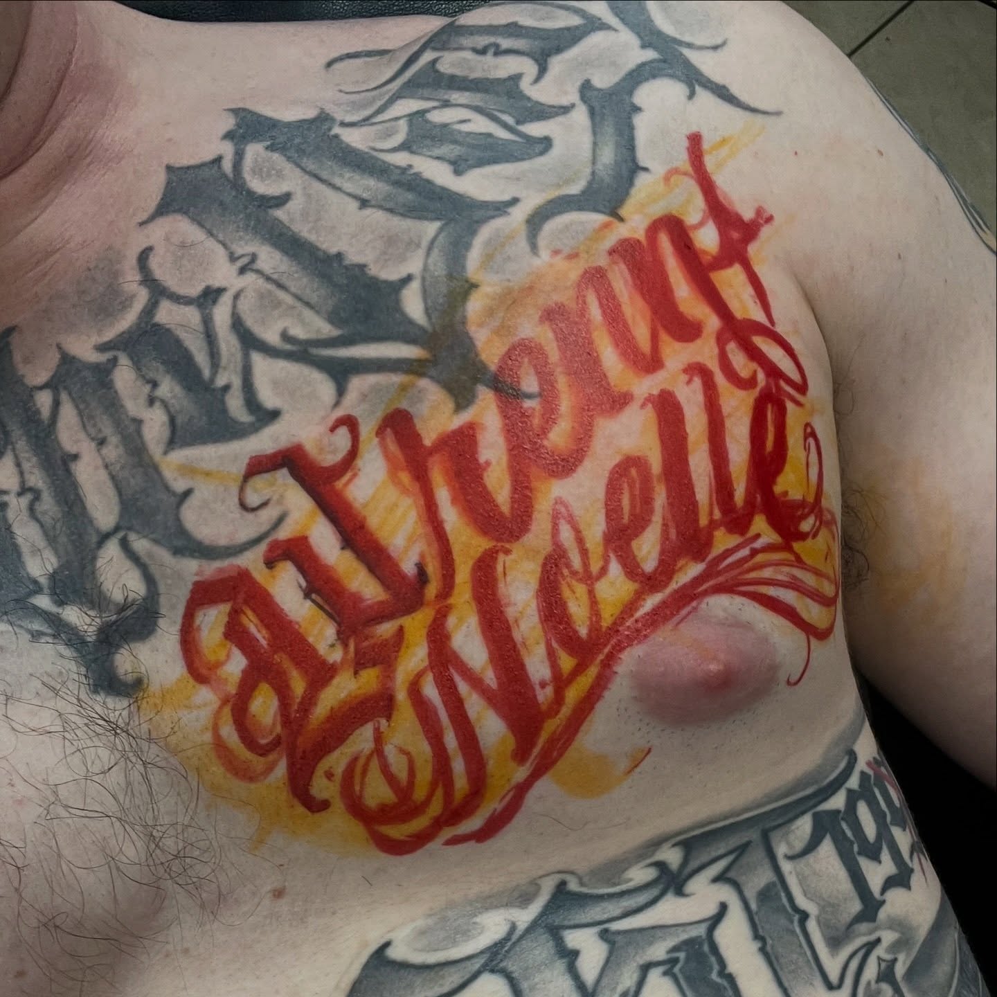 Alvèrent Nouelle lettering script tattoo on the chest by Shadoww Espinoza