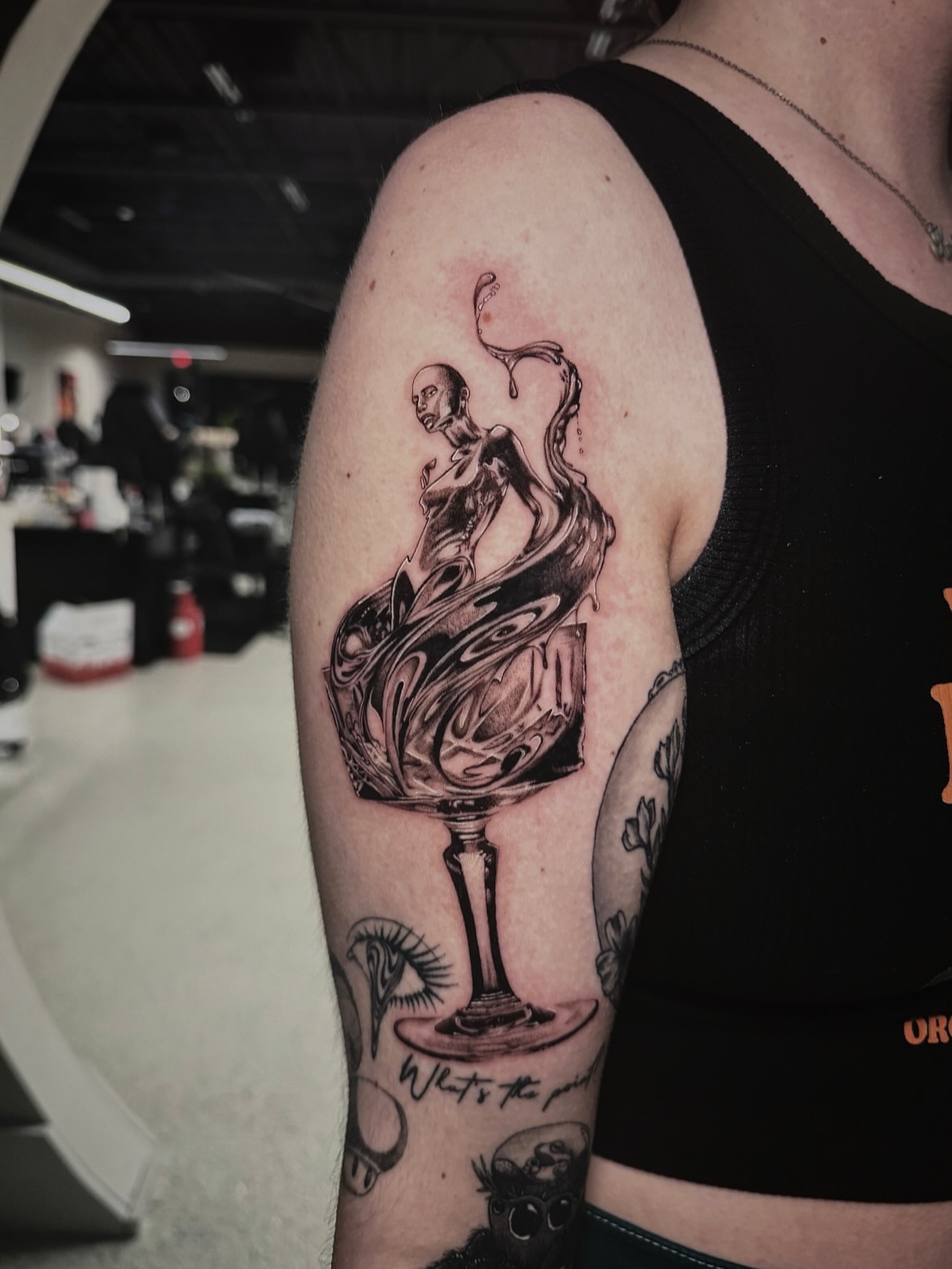 Spirit and glass realism tattoo on the forearm by Kelsey Zussman