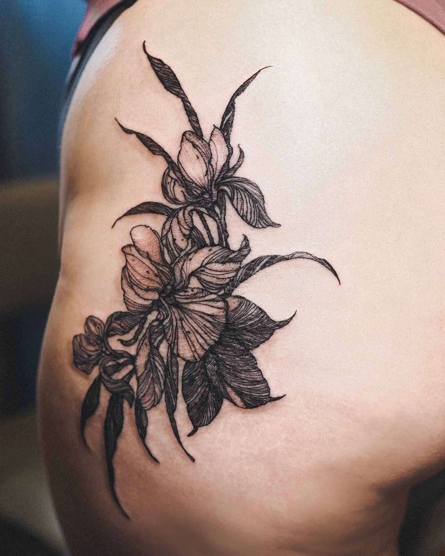 Flowers black and grey tattoo on the shoulder by Inks by Nastia