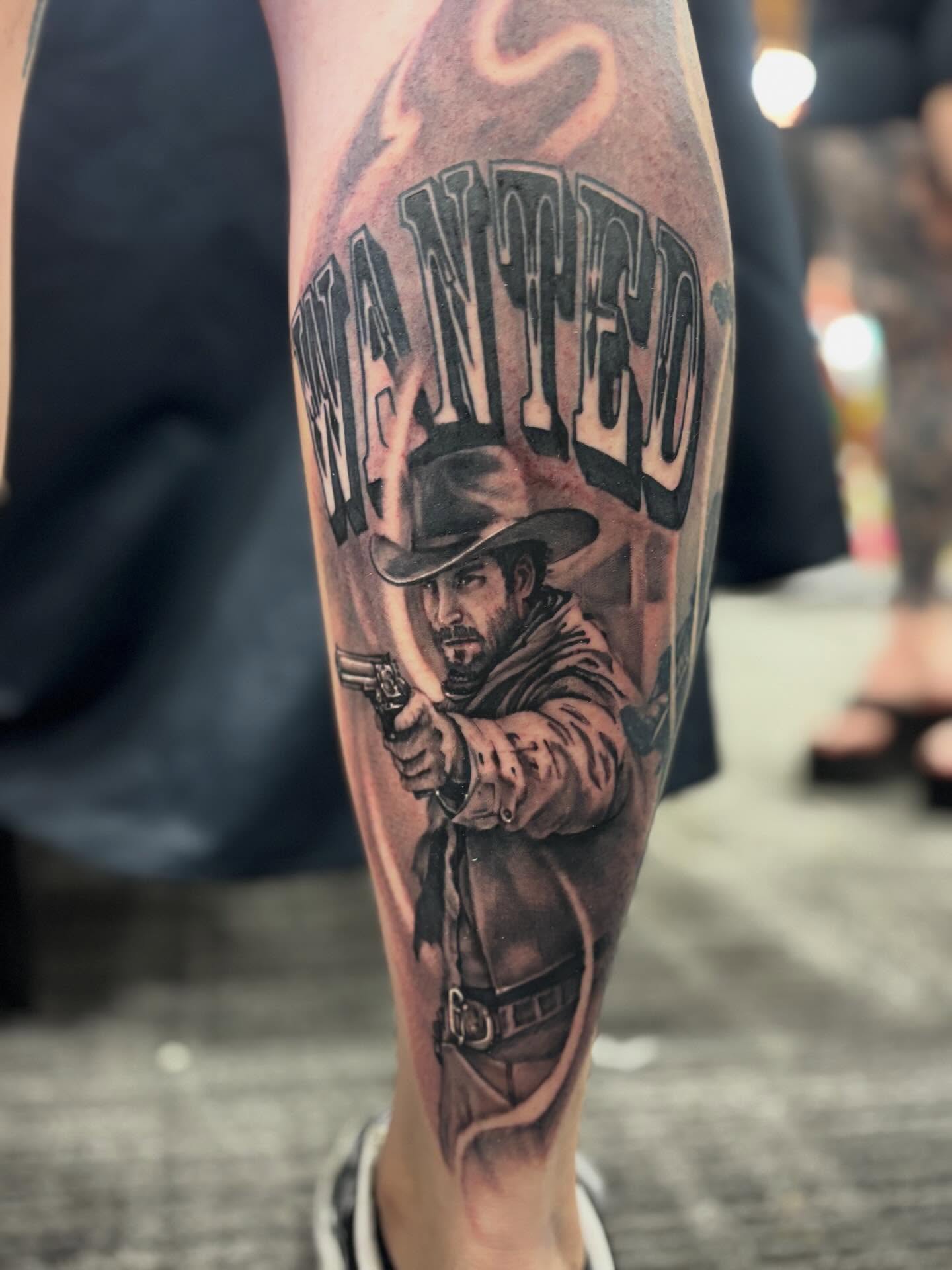 Cowboy wanted poster realism tattoo on the forearm by Johnny Scillieri