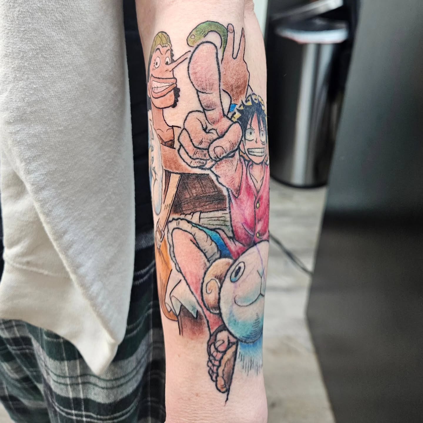 Anime characters anime tattoo on the forearm by Damian Eames