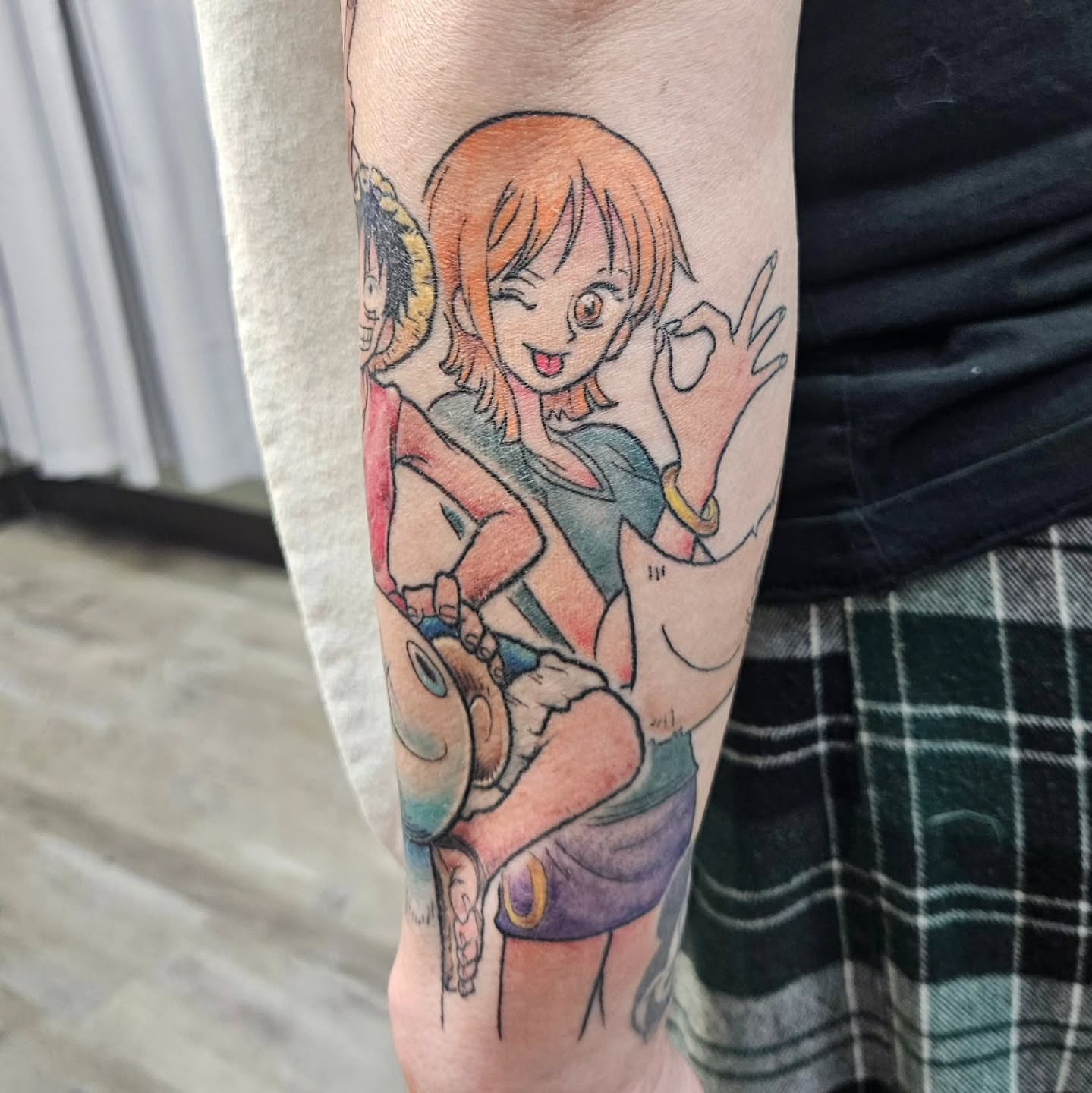 Anime character anime tattoo on the forearm by Damian Eames