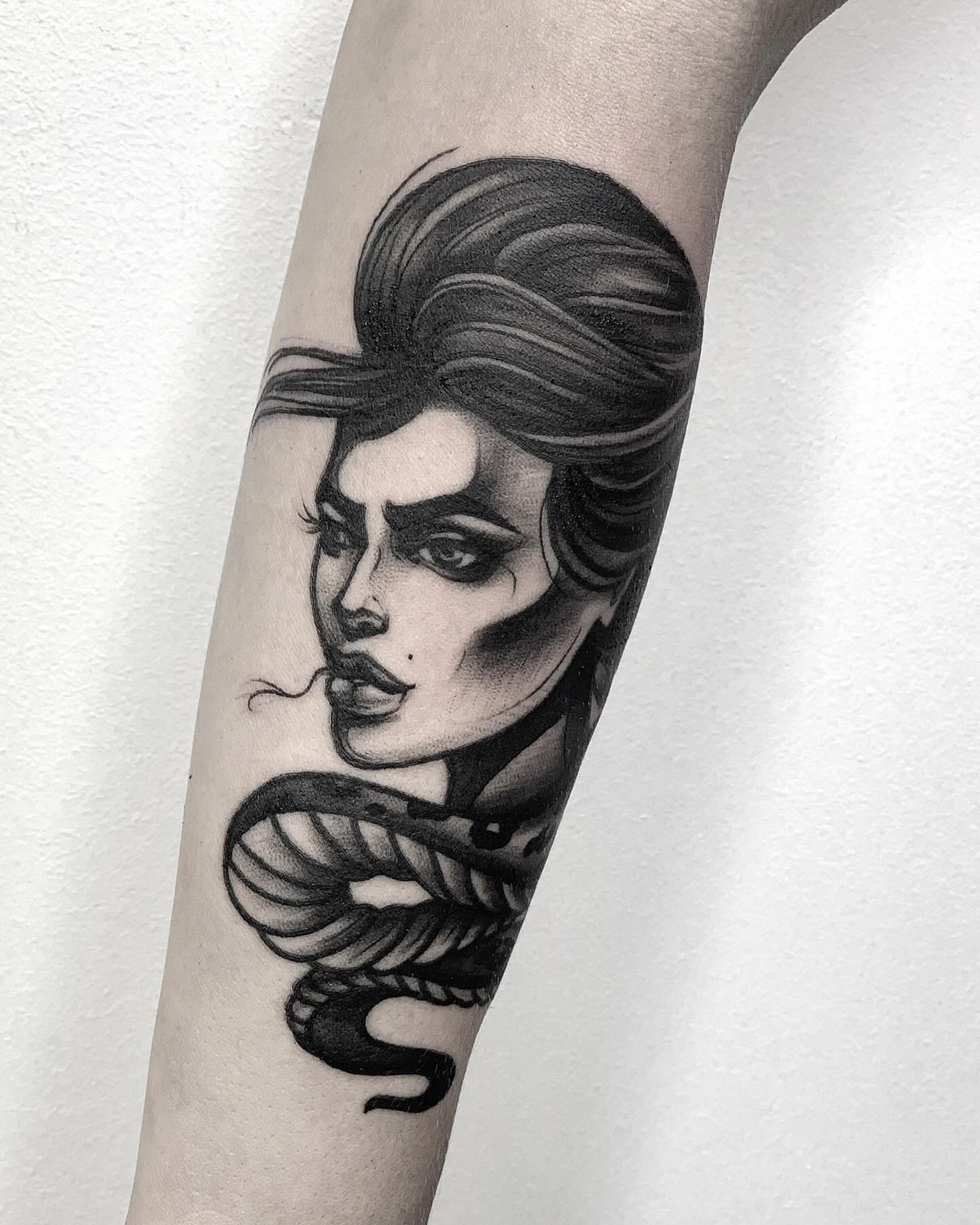 Woman with snake realism tattoo on the forearm by Elvira Savchuk