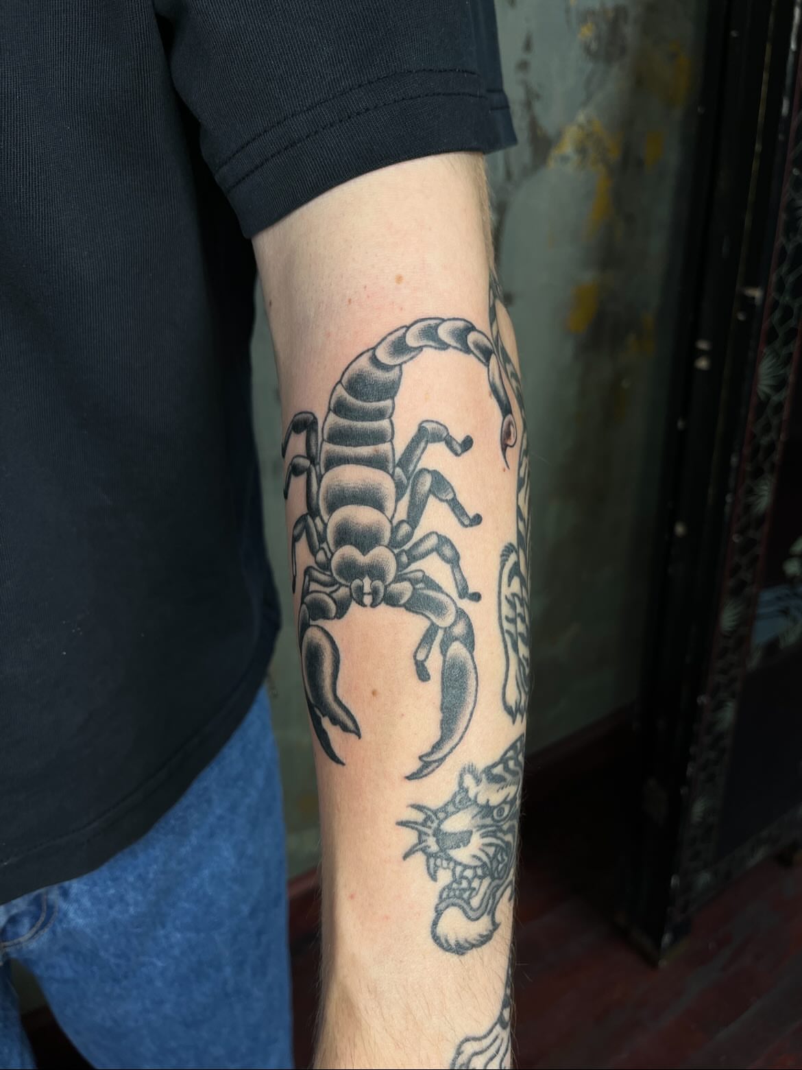 Scorpion black and grey tattoo on the forearm by Riley McDonald