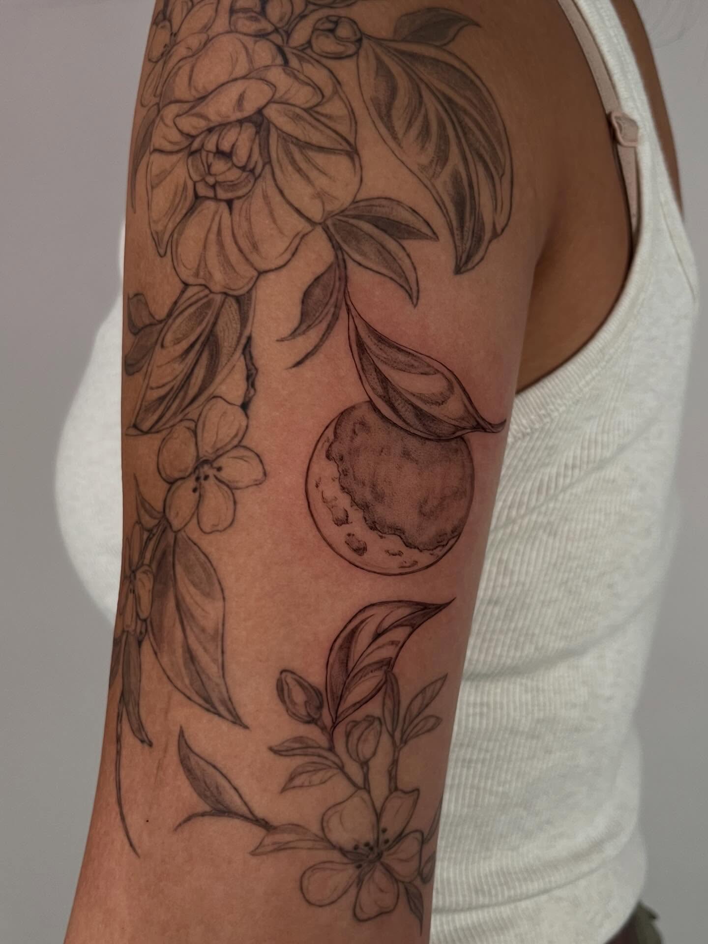 Peach and flowers black and grey tattoo on the forearm by Sierra Skye