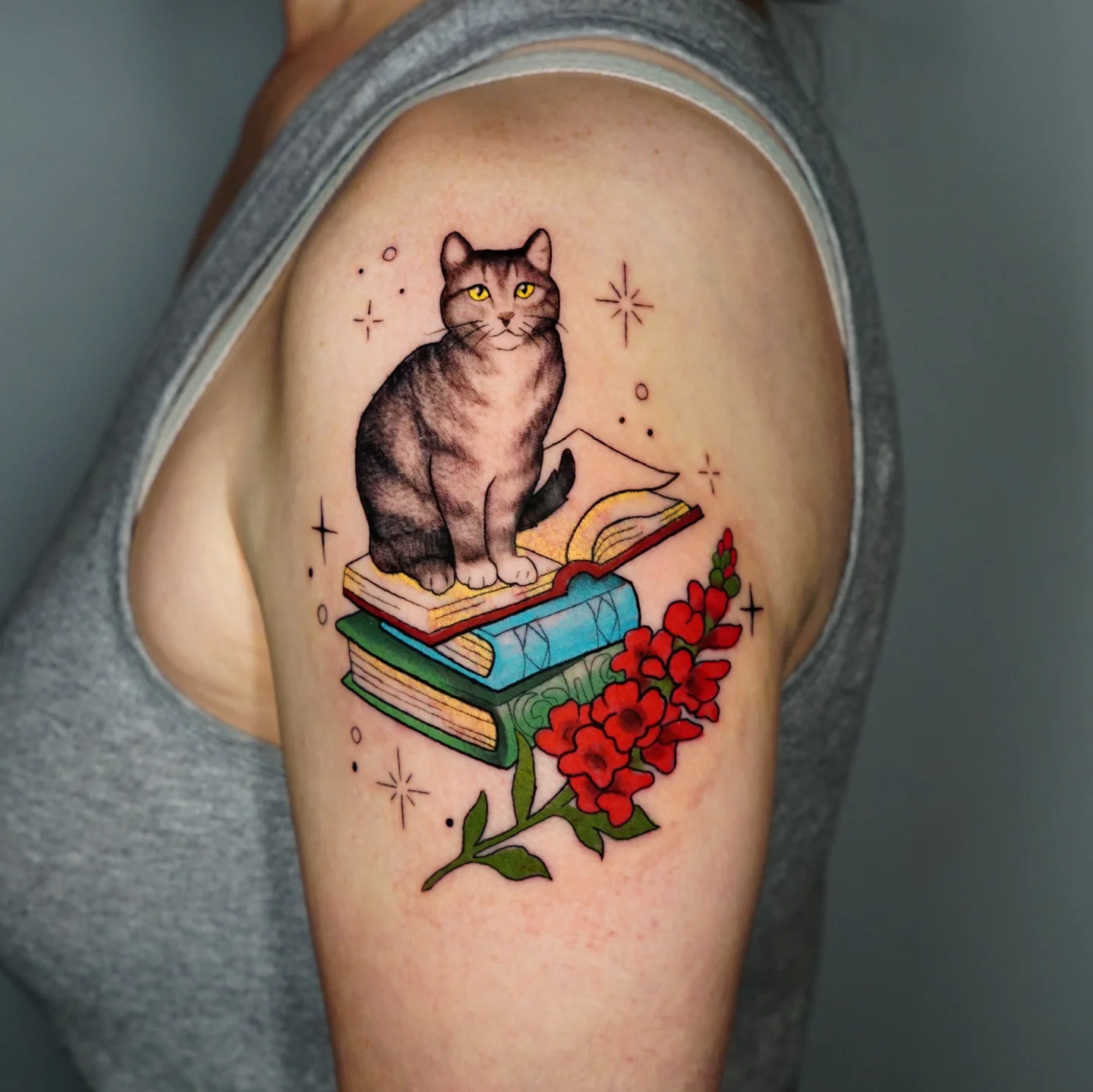 Cat on books American traditional tattoo on the shoulder by kylie, San Antonio, Texas