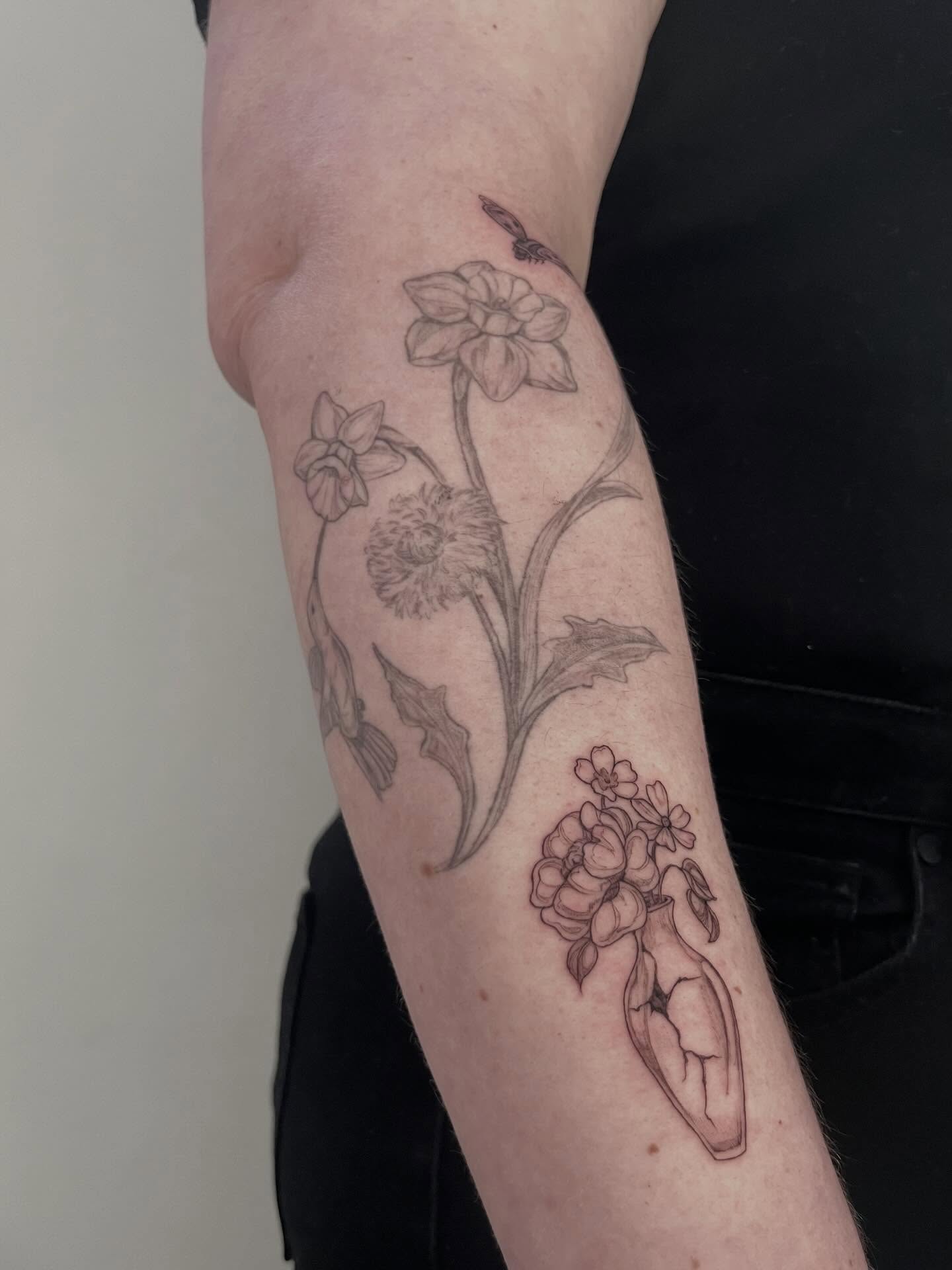Botanical arrangement realism tattoo on the forearm by Sierra Skye