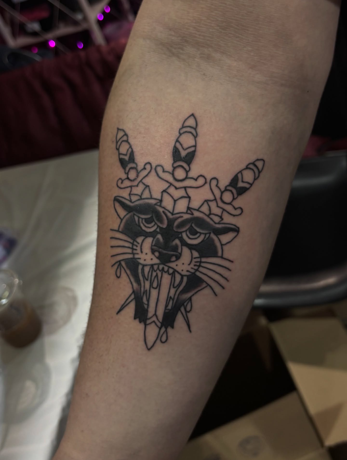 Panther with unicorn horns black and grey tattoo on the forearm by Nyah Ramirez