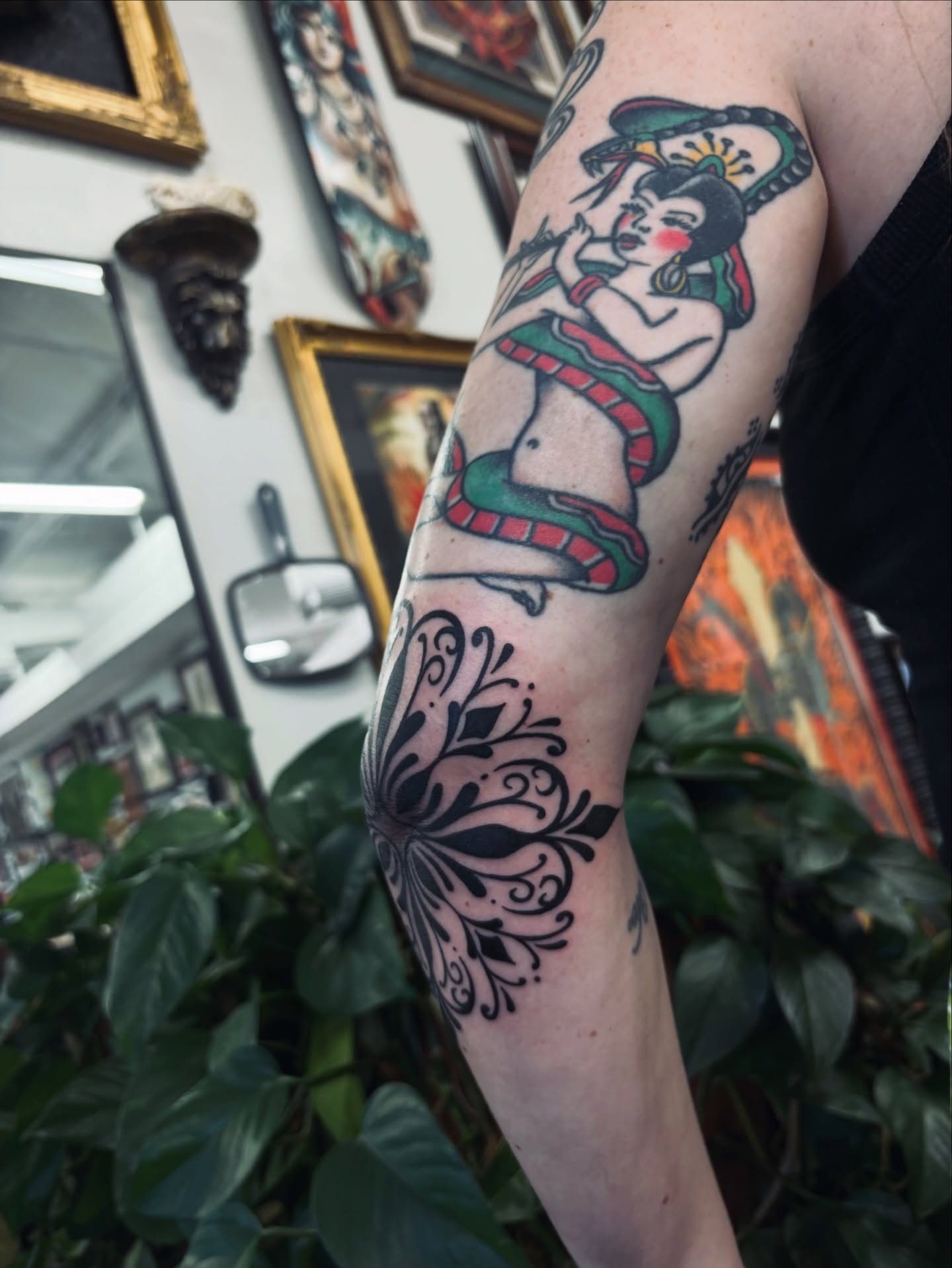 Woman with snake American traditional tattoo on the forearm by Kolbi Alexis