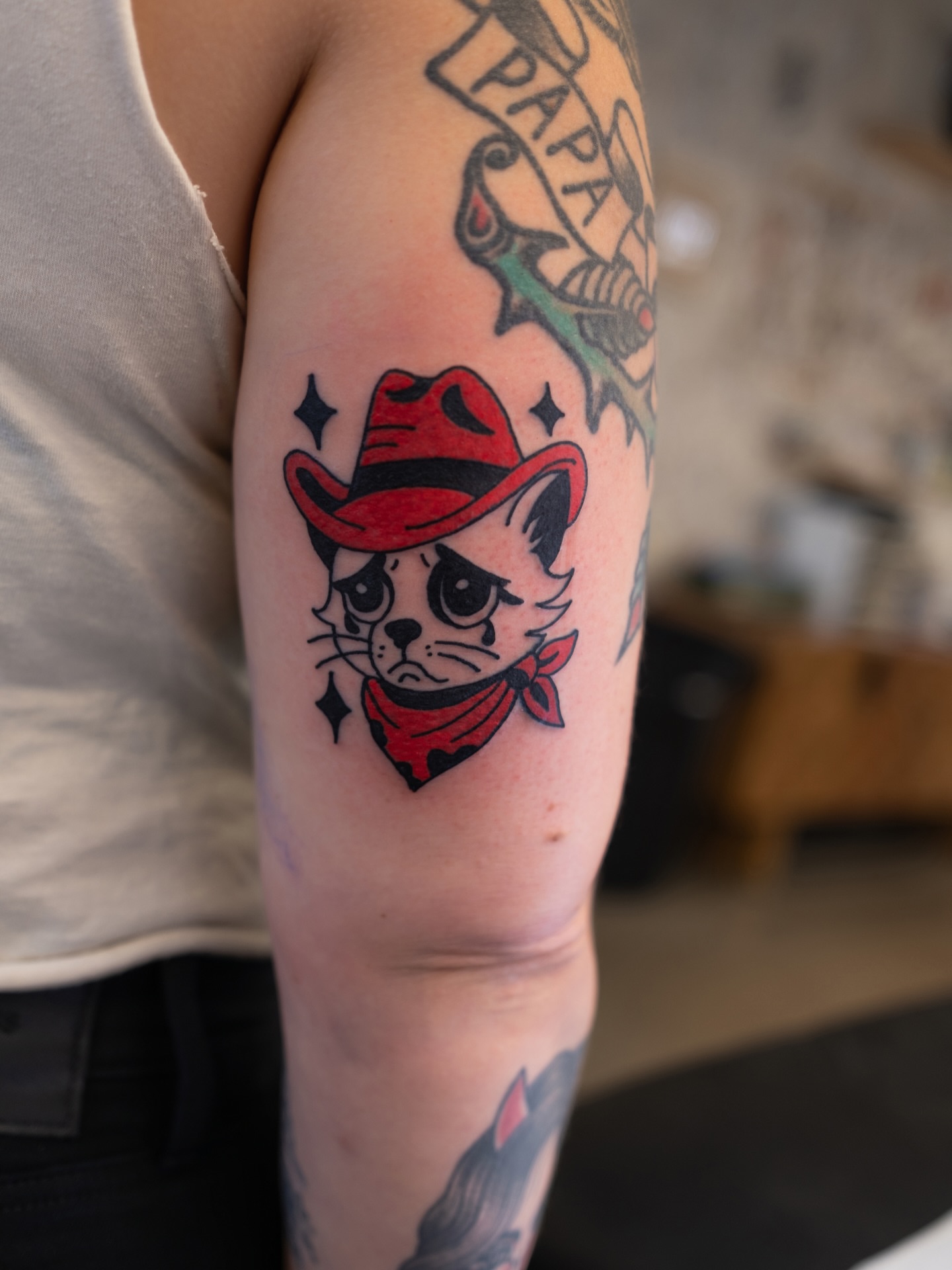 Cowboy cat American traditional tattoo on the forearm by Neto Velasco - Sad Cat Tattoo, Austin, Texas