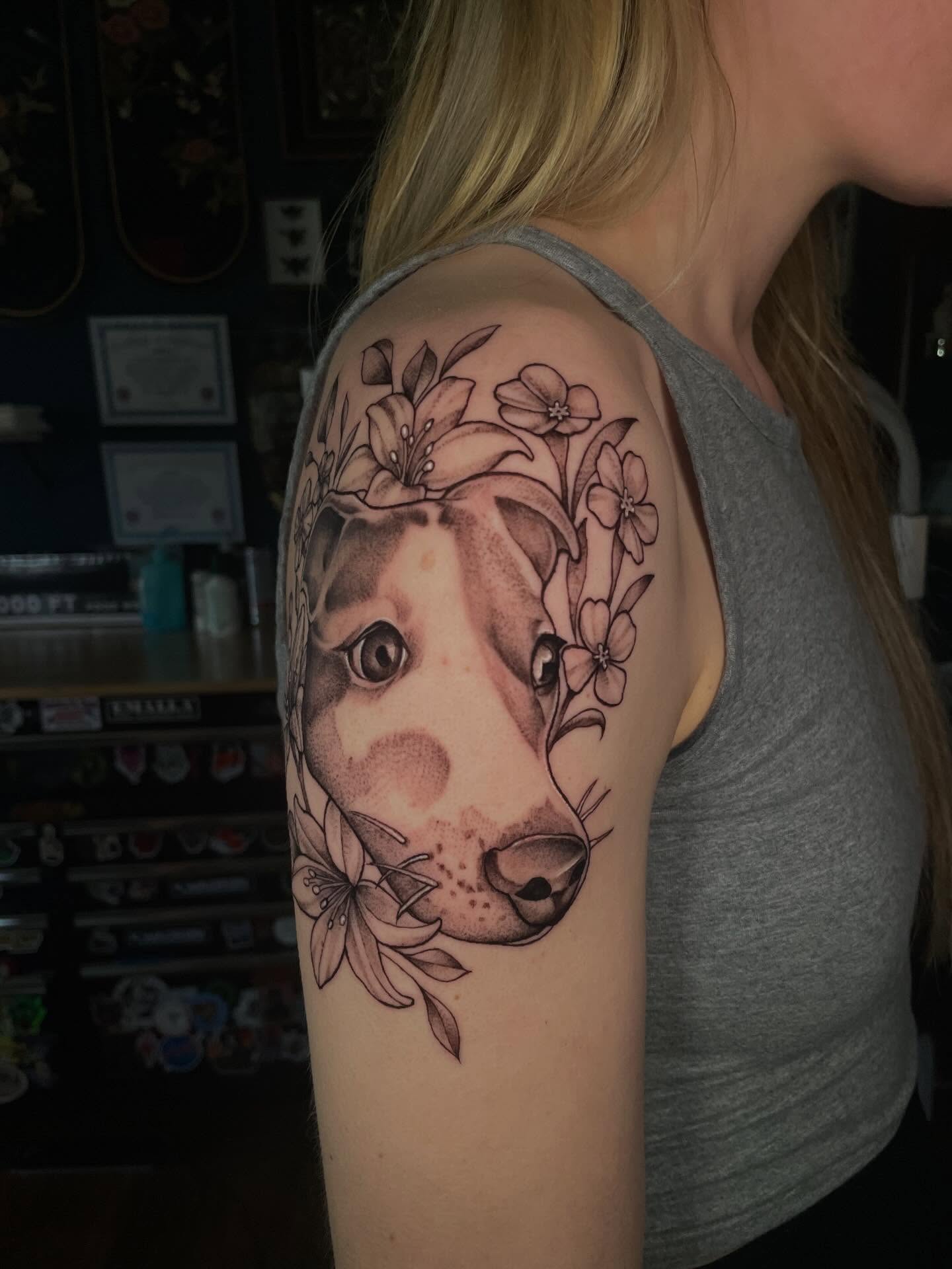 Dog with flowers realism tattoo on the shoulder by Lauren Sisouphanh, Canton, Ohio