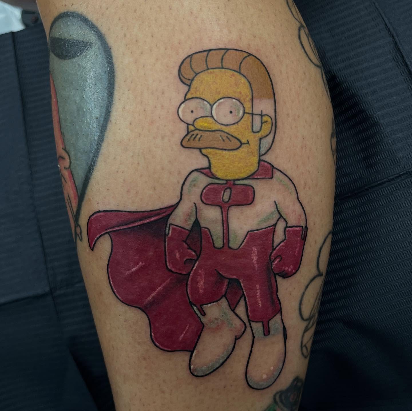 Homer Simpson as superhero new school tattoo on the forearm by @artinjections667