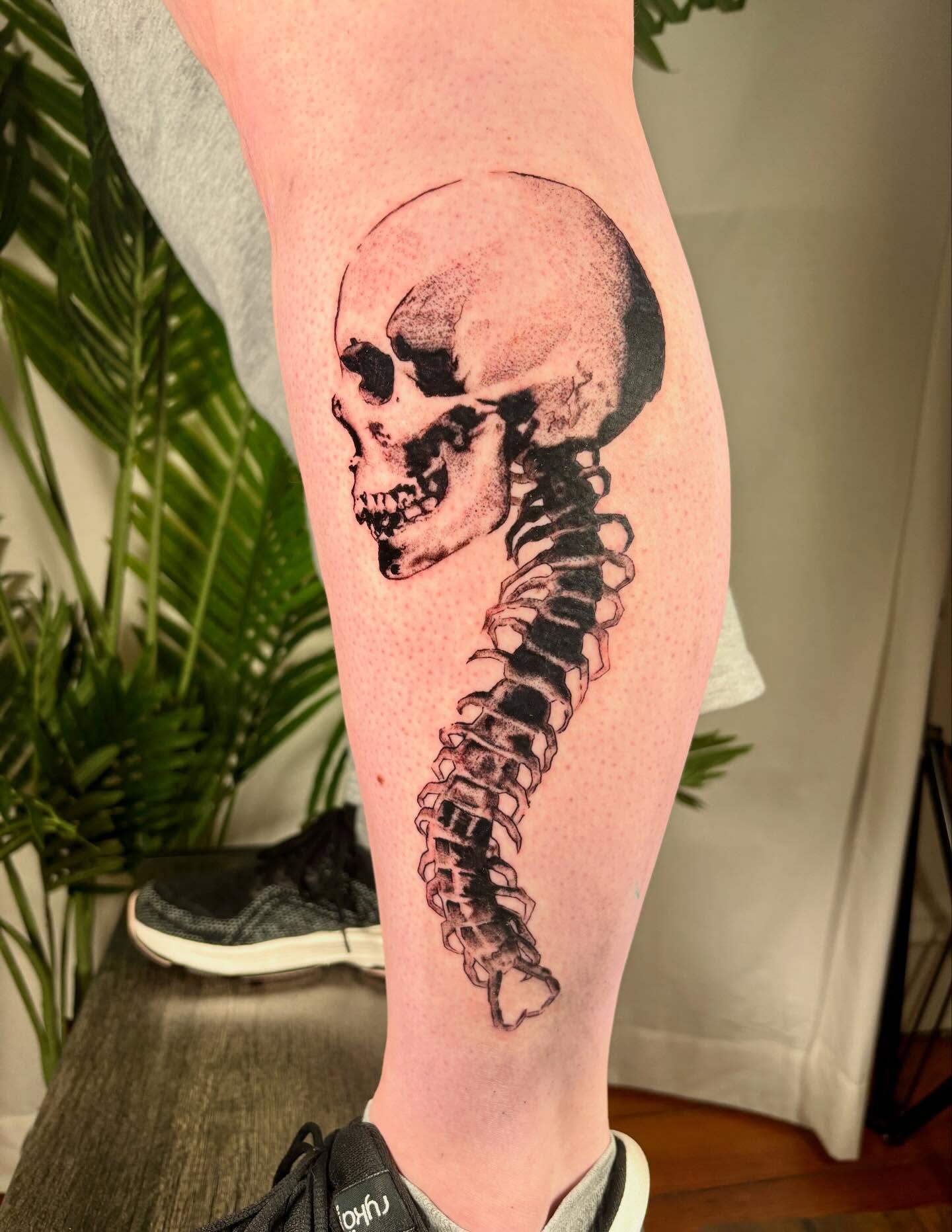 Skull and spine realism tattoo on the calf by Davie Tattoos