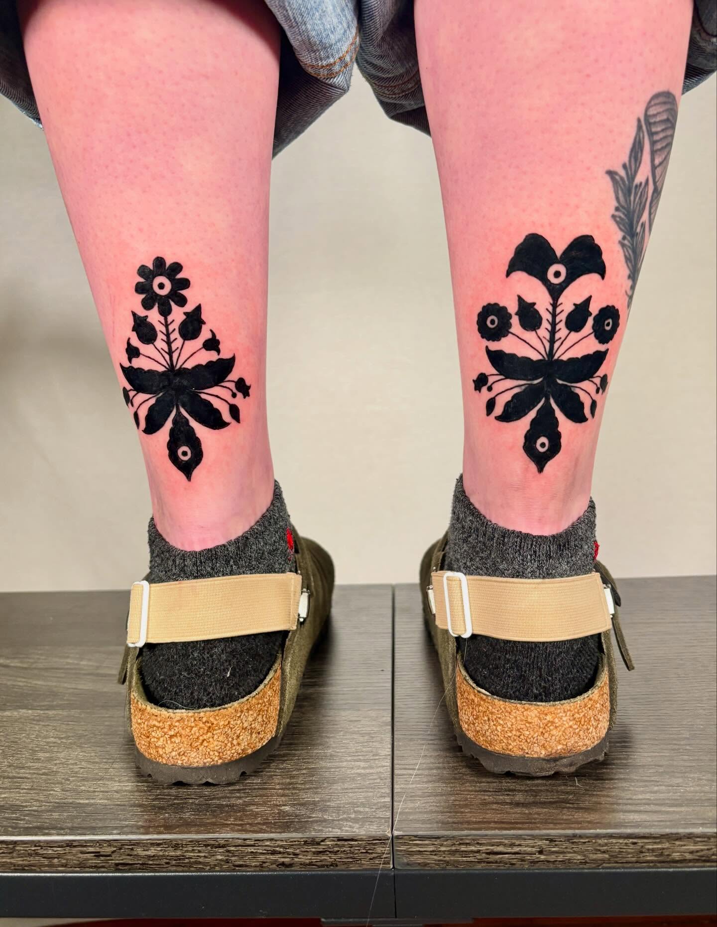 Floral motif black and grey tattoo on the calf by Davie Tattoos