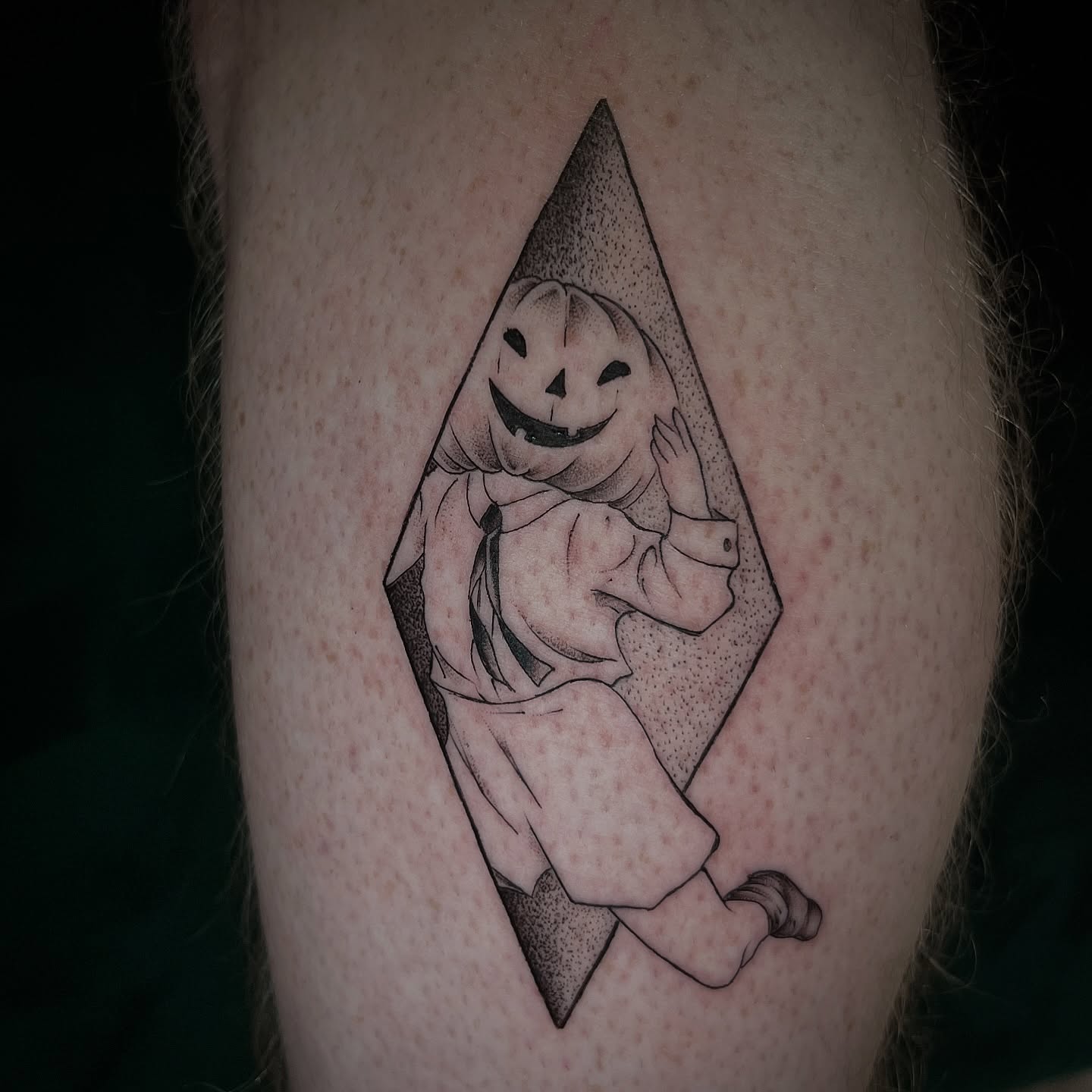 Pumpkin ghost dotwork tattoo on the thigh by Jen Rahman