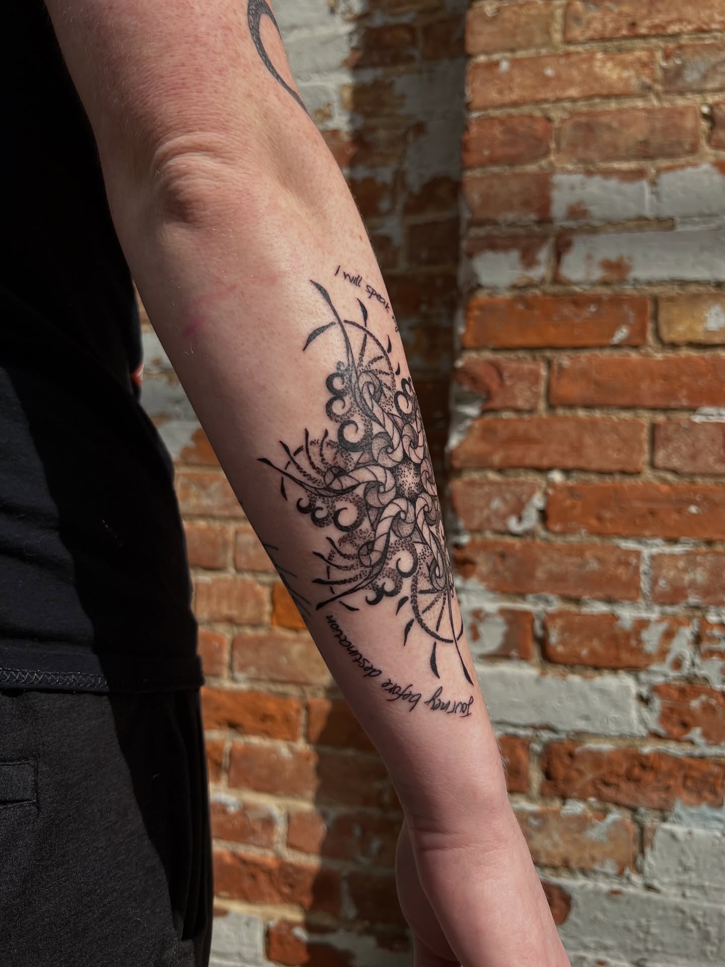 Floral design black and grey tattoo on the forearm by Riley
