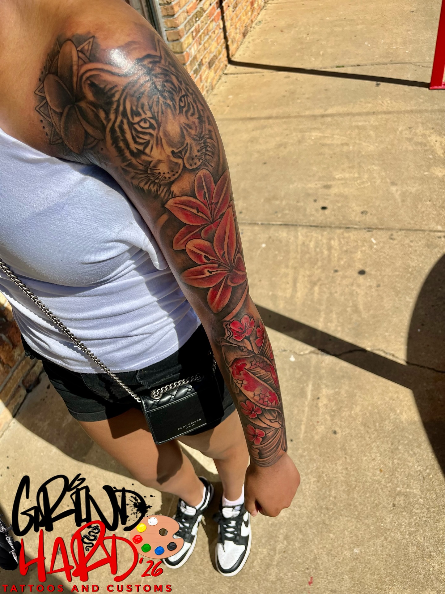 Tiger and flowers realism tattoo on the upper arm by GrindHard Quen