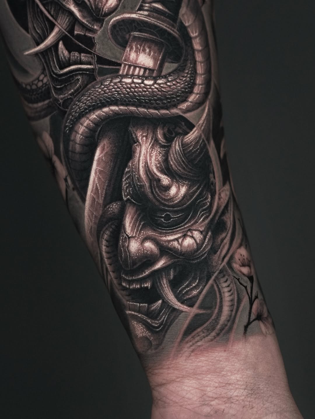 Oni mask and snake Japanese tattoo on the forearm by Sumok Kim