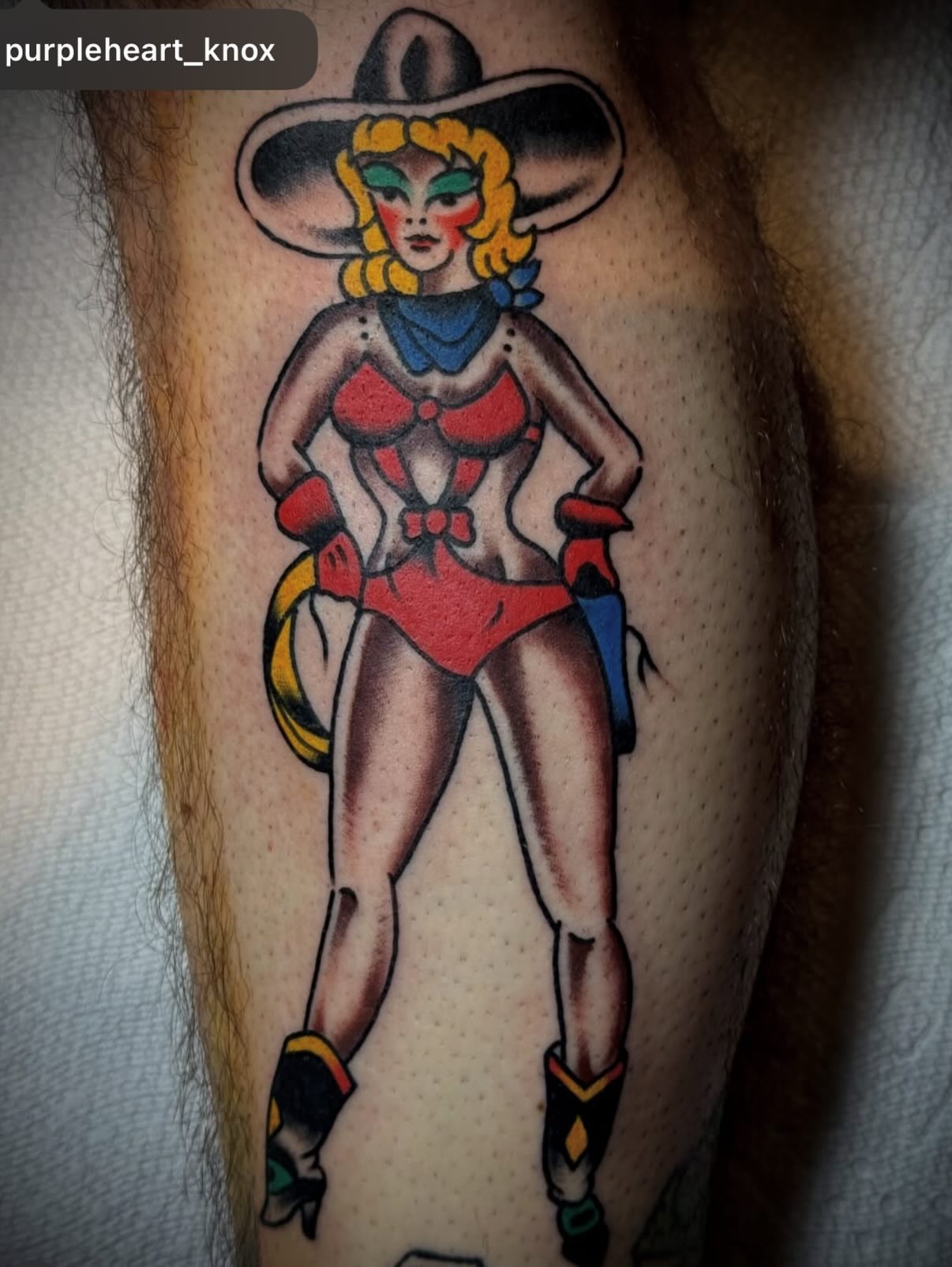 Cowgirl pin-up American traditional tattoo on the forearm by Chuck Derek Whitaker