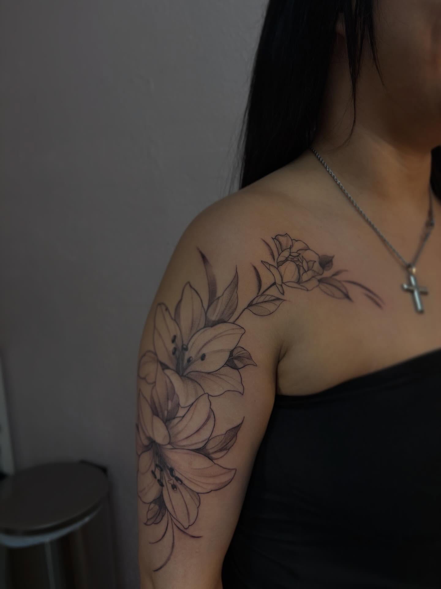Lilies black and grey tattoo on the shoulder by Jackie π€