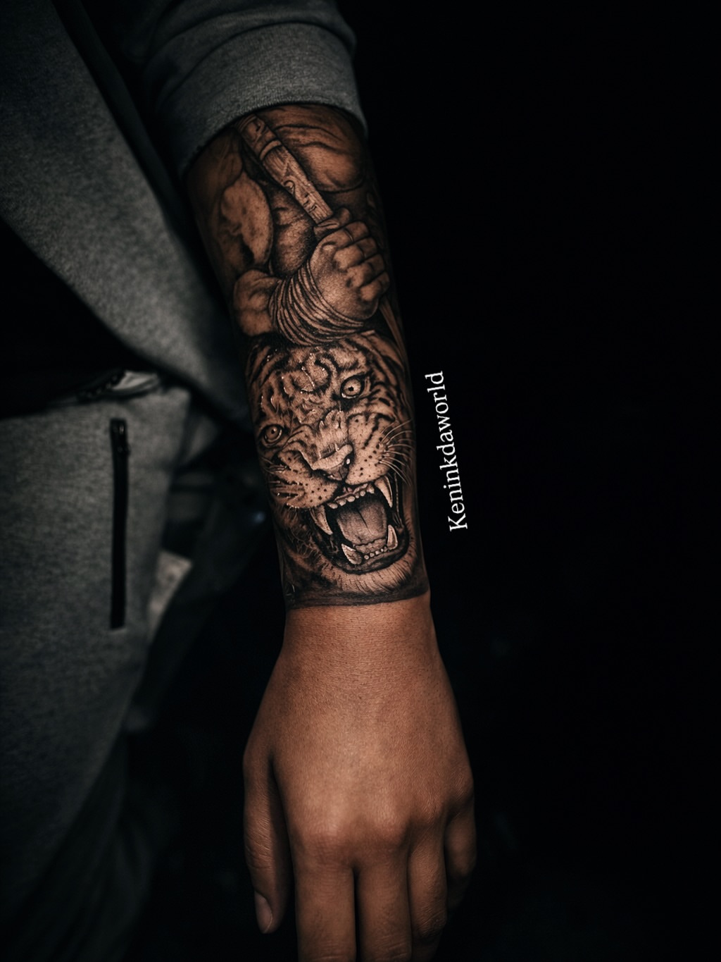 Roaring lion realism tattoo on the forearm by Ken West