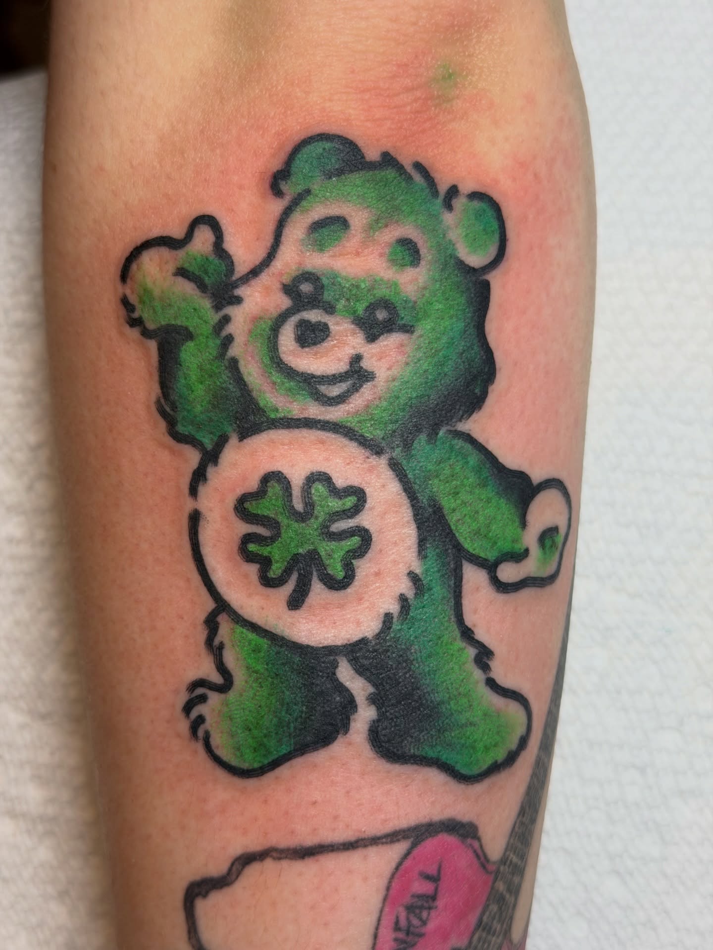 Green bear with clover American traditional tattoo on the forearm by 🌈KNOXVILLE’S FAVORITE TATTOO ARTIST 👽 마법 버섯