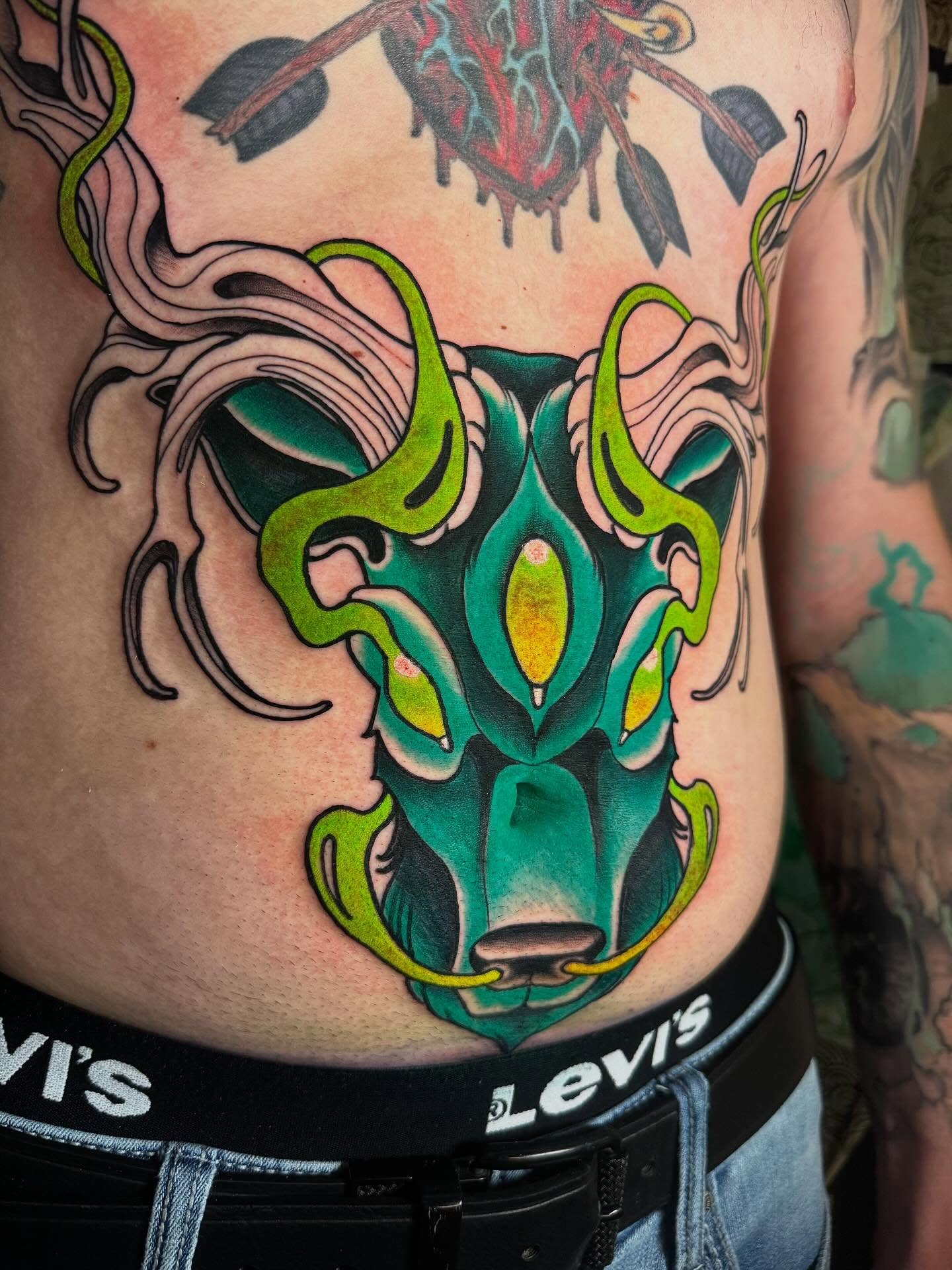 Bull mask new school tattoo on the ribs by Jess Longfield, Des Moines, Iowa
