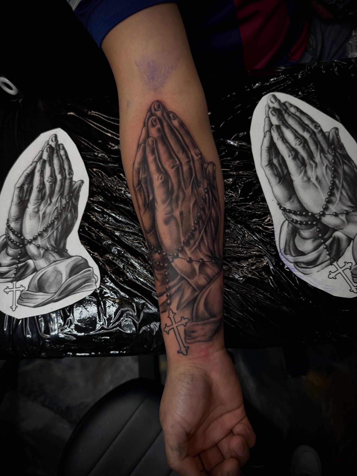Praying hands black and grey tattoo on the forearm by Santi🎲