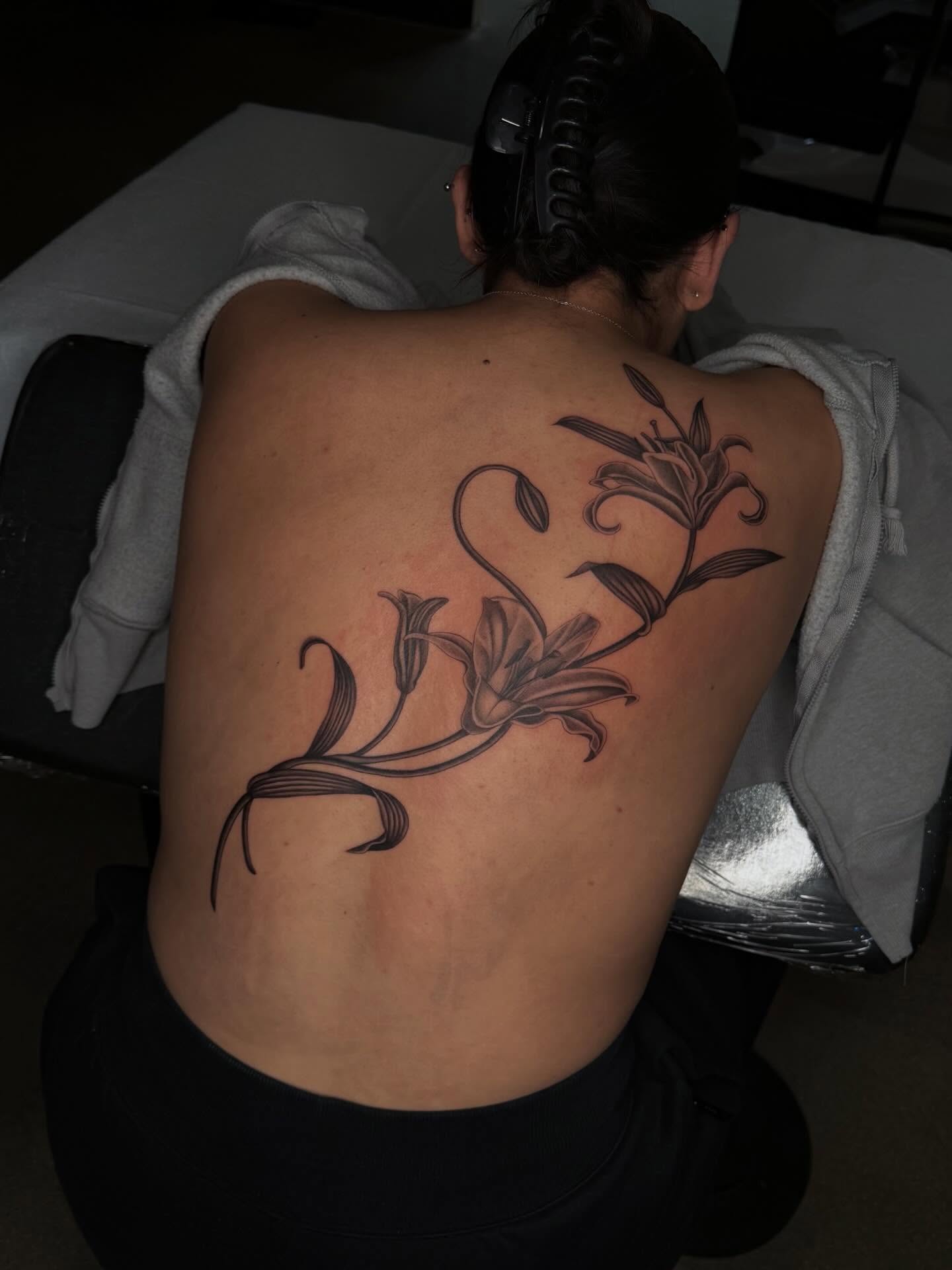 Lily black and grey tattoo on the back by Nayoung, San Francisco, California