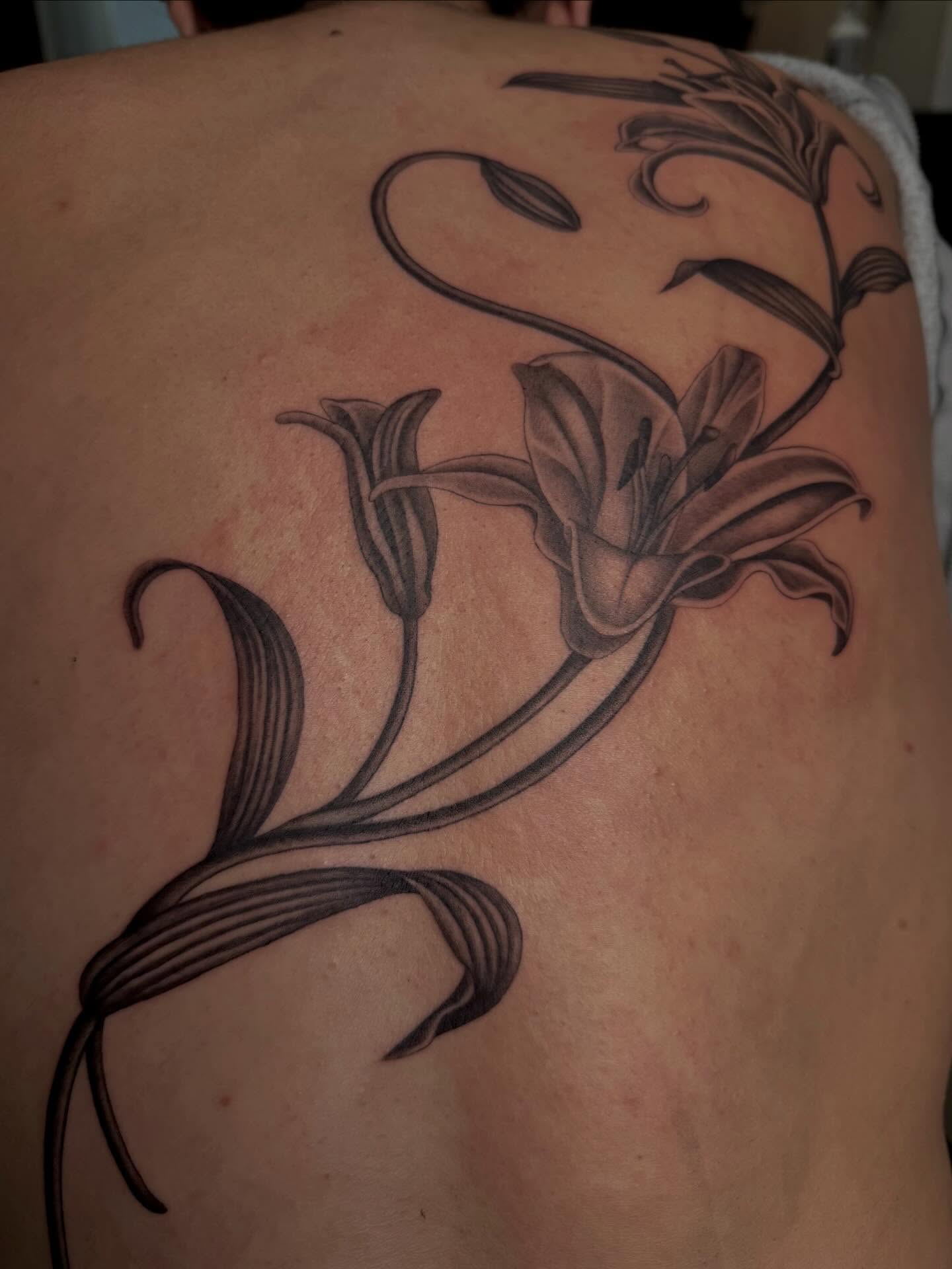 Lily black and grey tattoo on the back by Nayoung, San Francisco, California