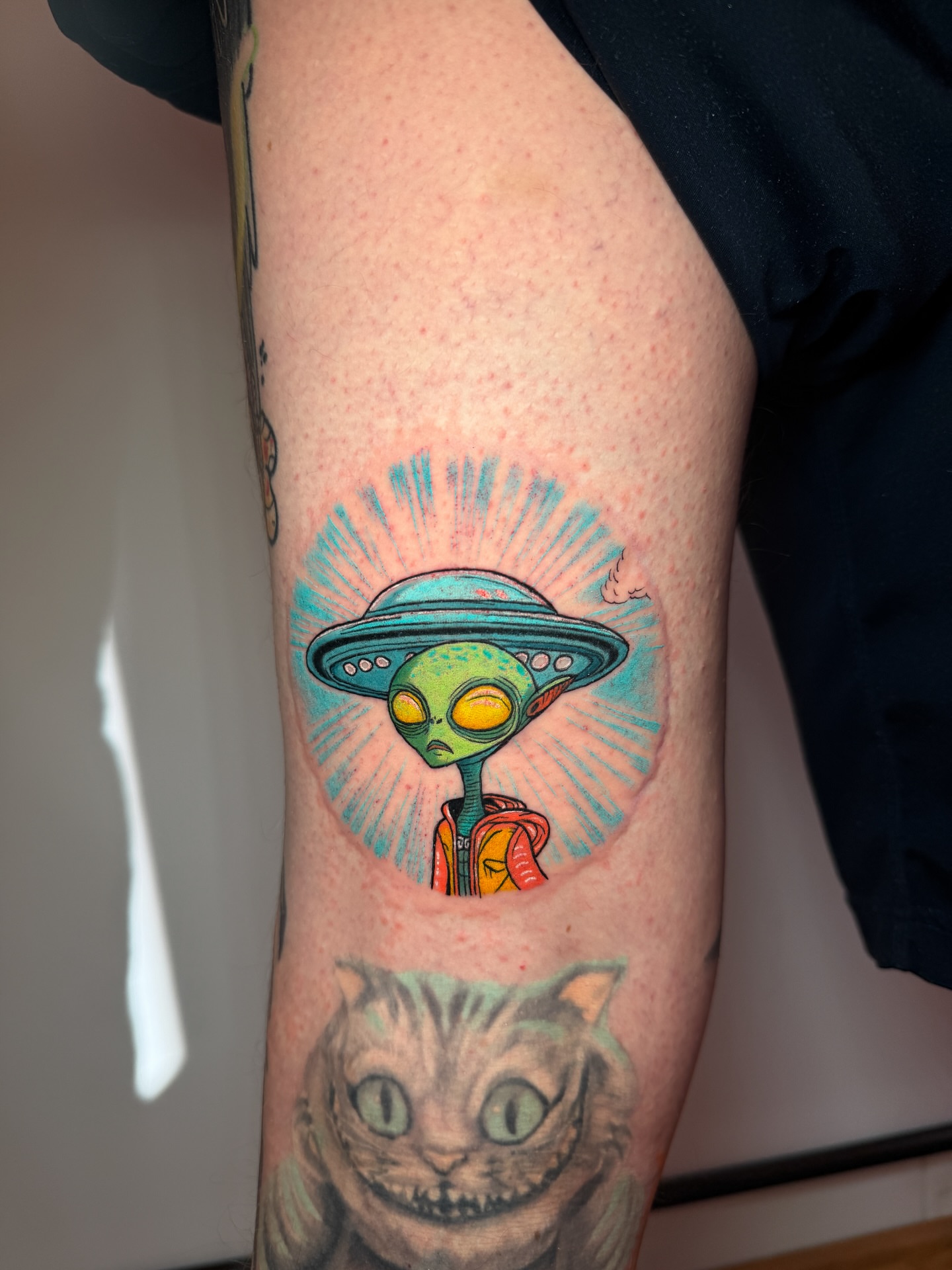 Alien with UFO illustrative tattoo on the forearm by Tattoo Artist Los Angeles