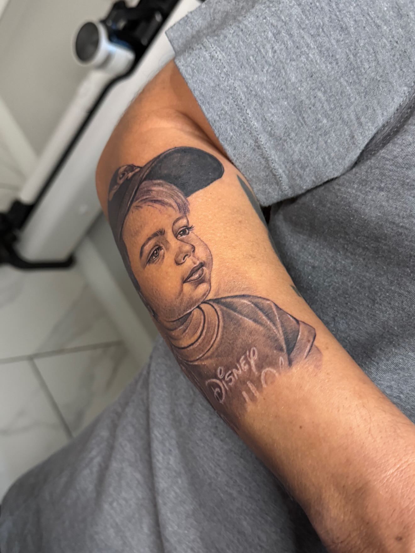 Child portrait realism tattoo on the forearm by Adrian gonzalez...