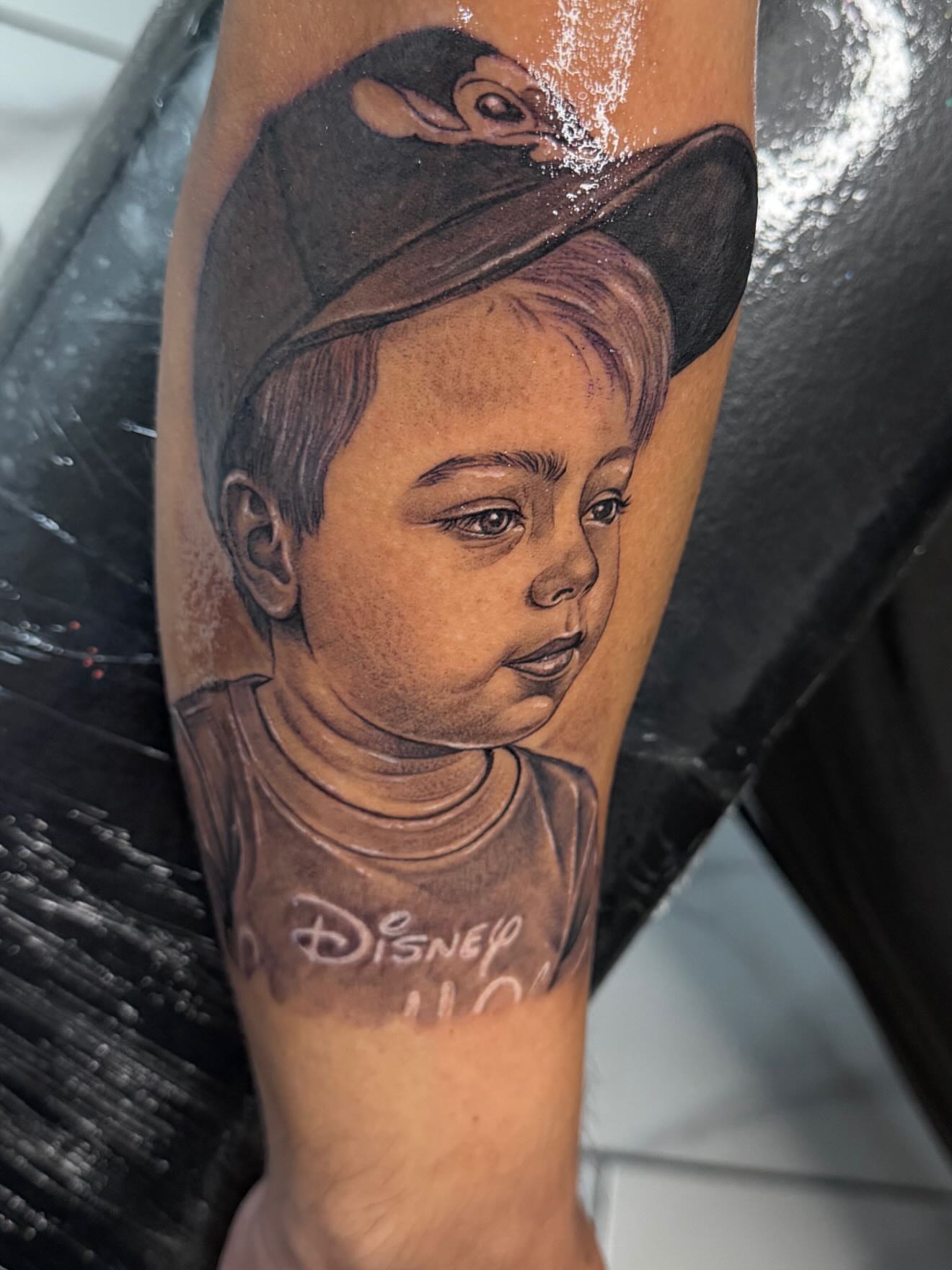 Child portrait realism tattoo on the forearm by Adrian gonzalez...
