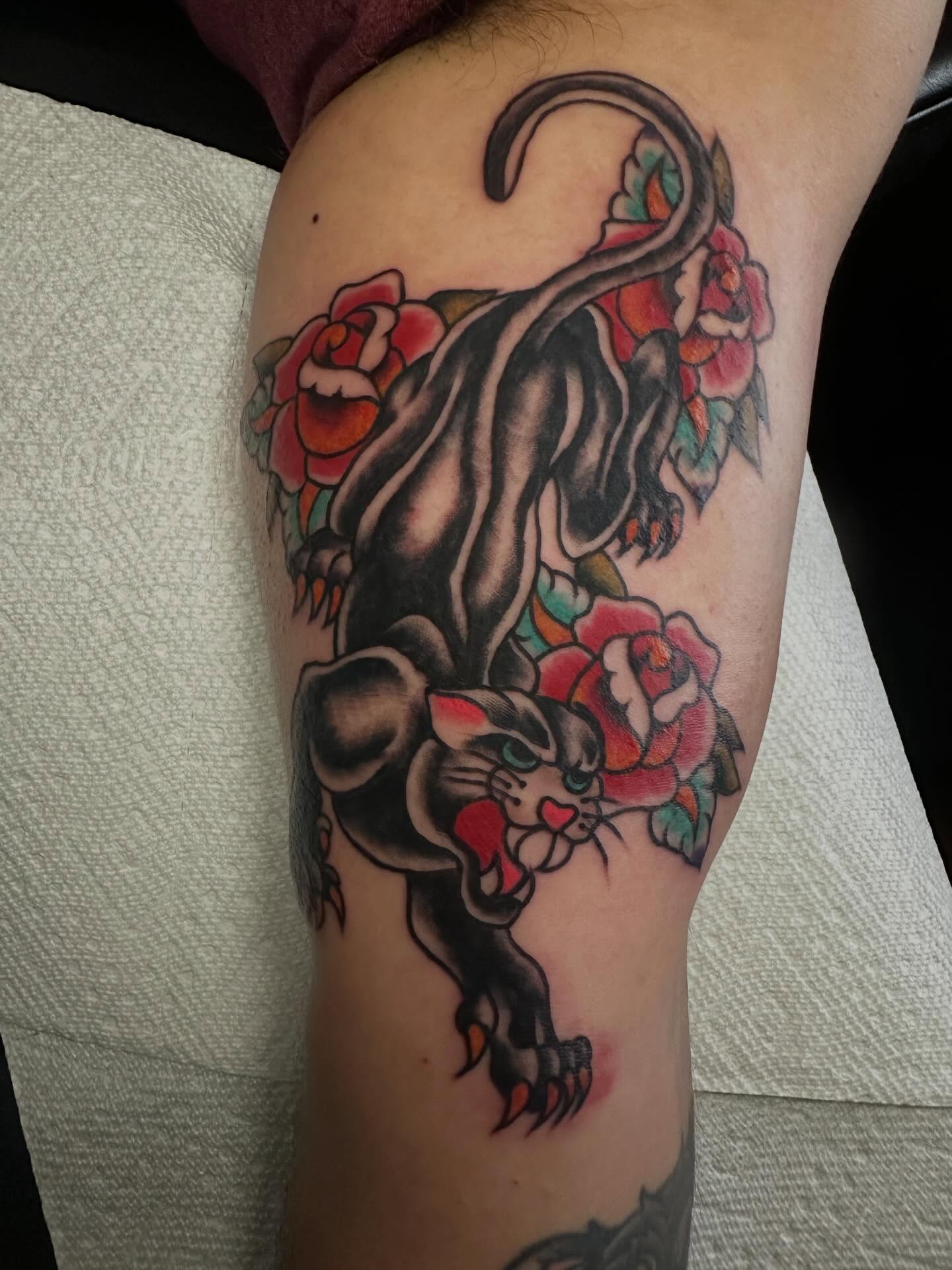 Cat and roses American traditional tattoo on the thigh by Elisha B🦷