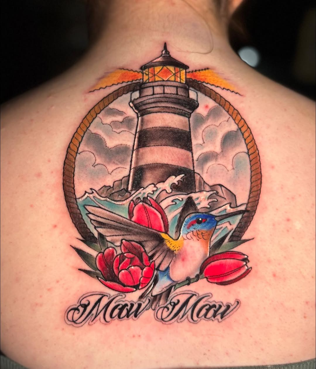 Lighthouse, hummingbird, flowers, and script neo-traditional tattoo on the back by Dustin Schild, Memphis, Tennessee
