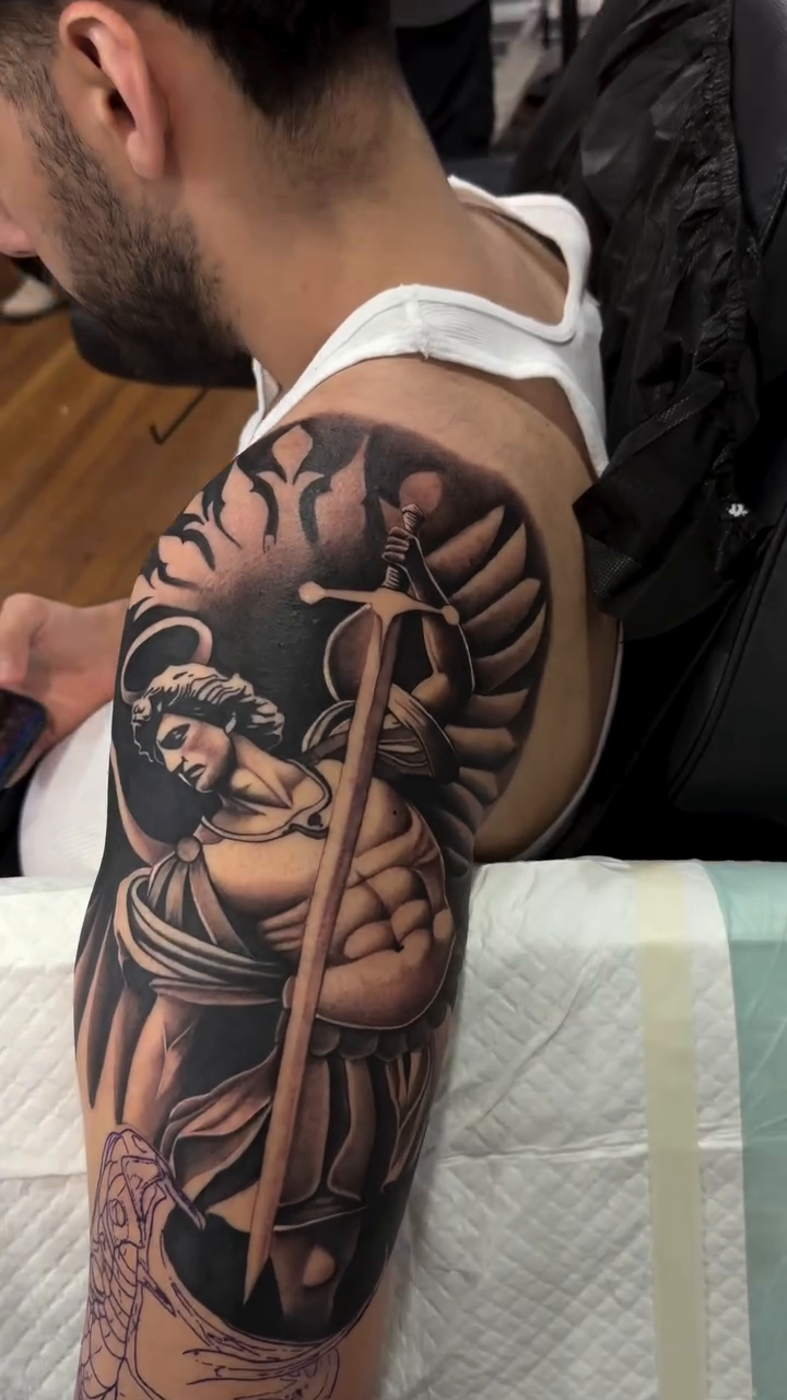 Angel with sword realism tattoo by caleb coley