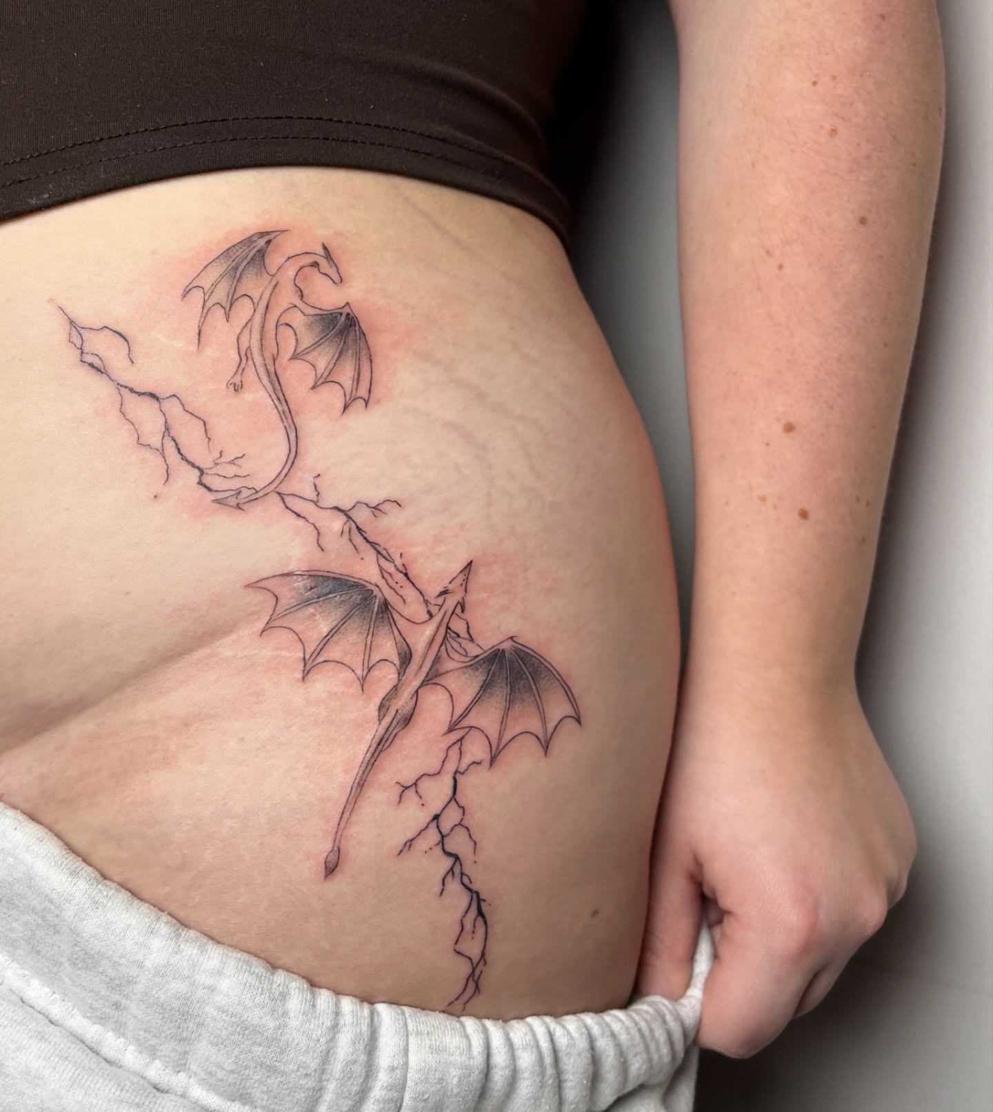 Dragon black and grey tattoo on the ribs by brinley - fine line tattoos, Crescent Springs, Kentucky
