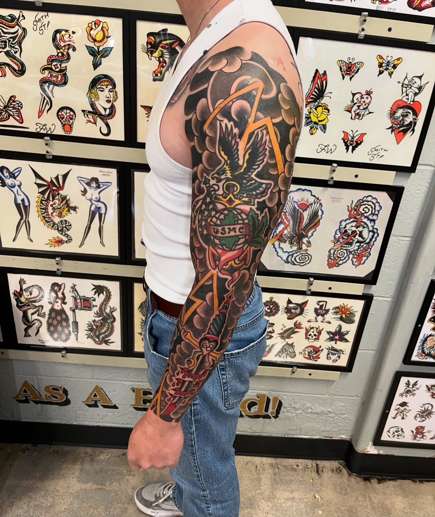 Arm sleeve American traditional tattoo on the upper arm by Tim Howell