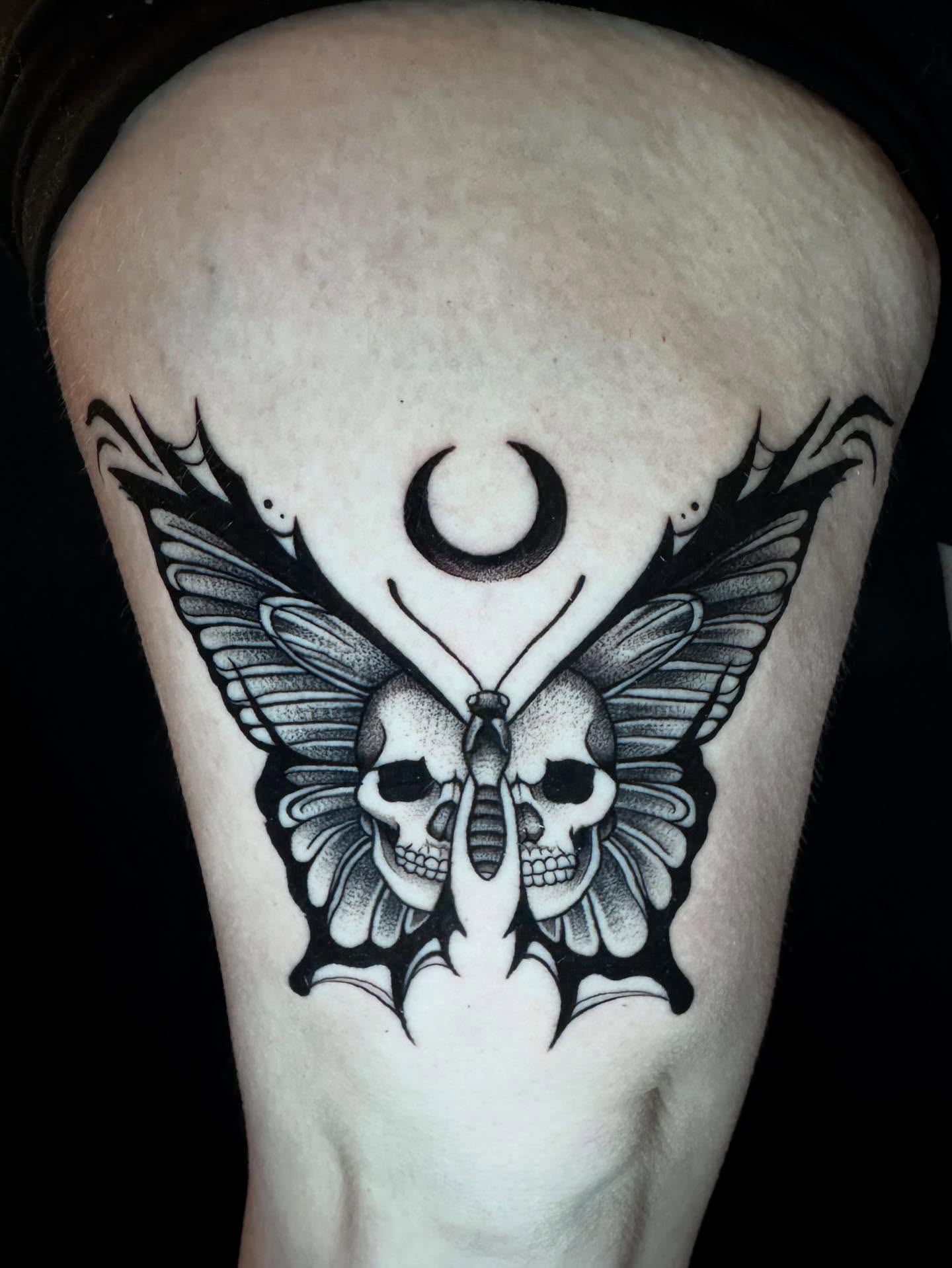 Skull butterfly dotwork tattoo on the thigh by Morgan Peeples