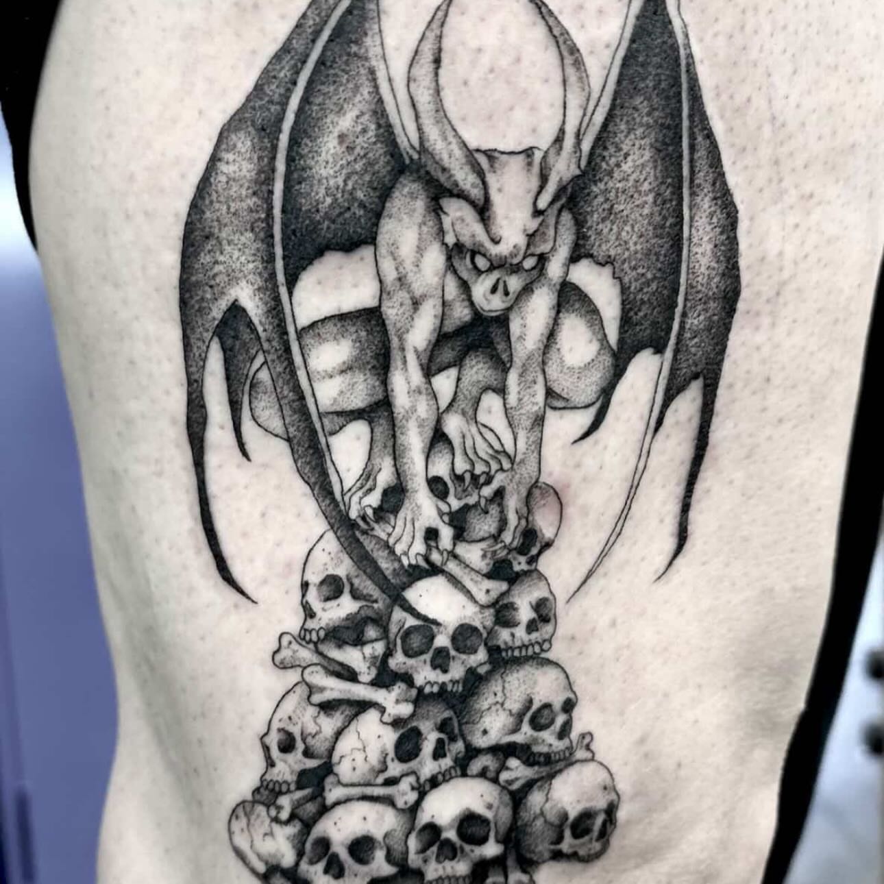 Gargoyle and skulls realism tattoo on the thigh by Zoe D