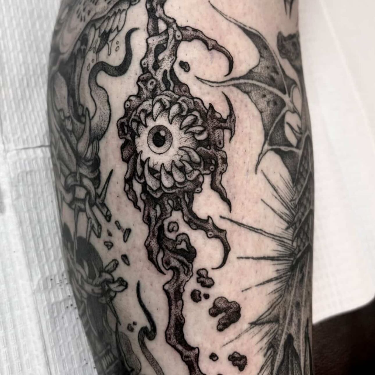 Eye with organic tendrils dotwork tattoo on the forearm by Zoe D