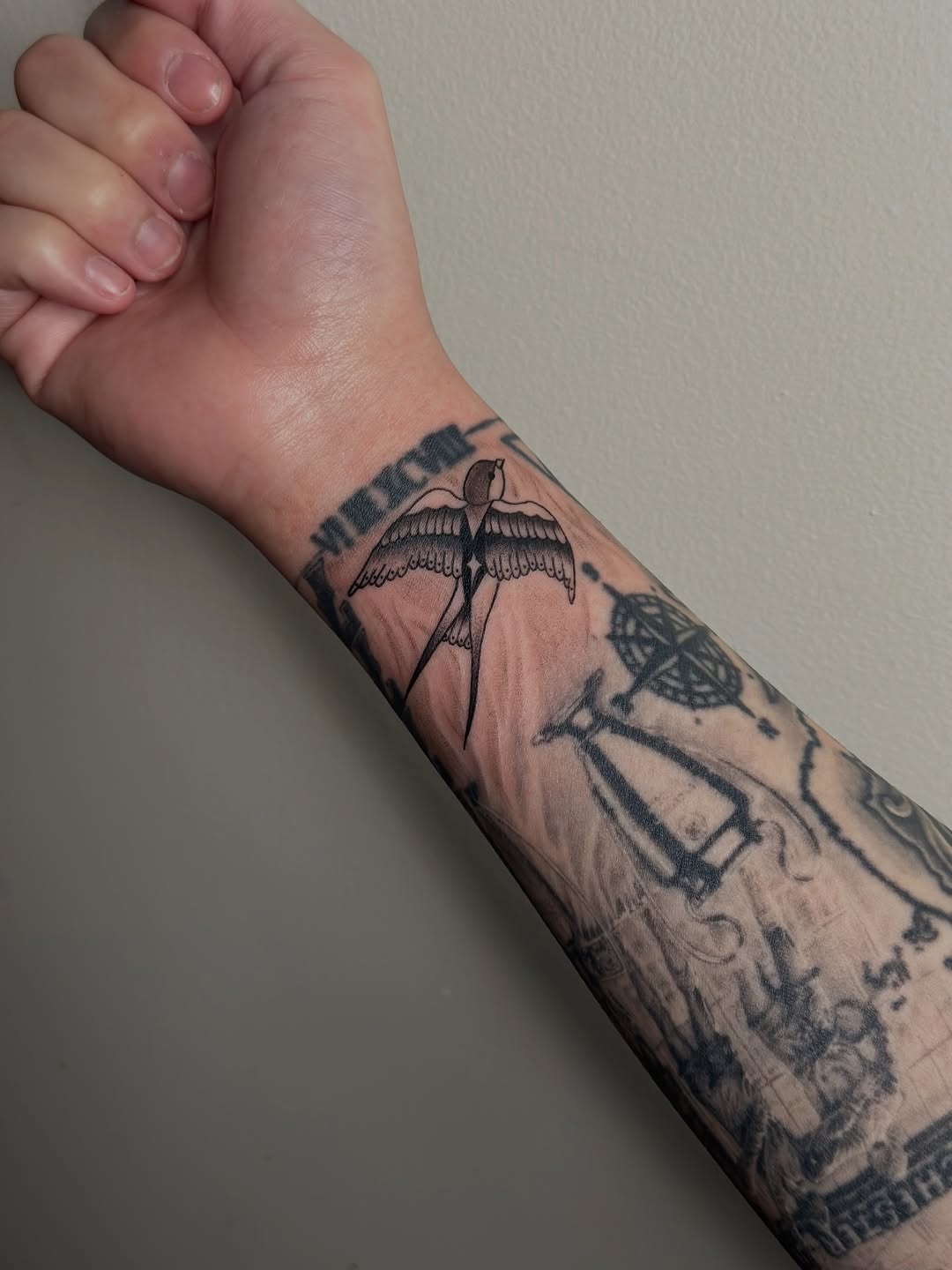 Swallow and roman numerals fine line tattoo on the forearm by Cherry🥀
