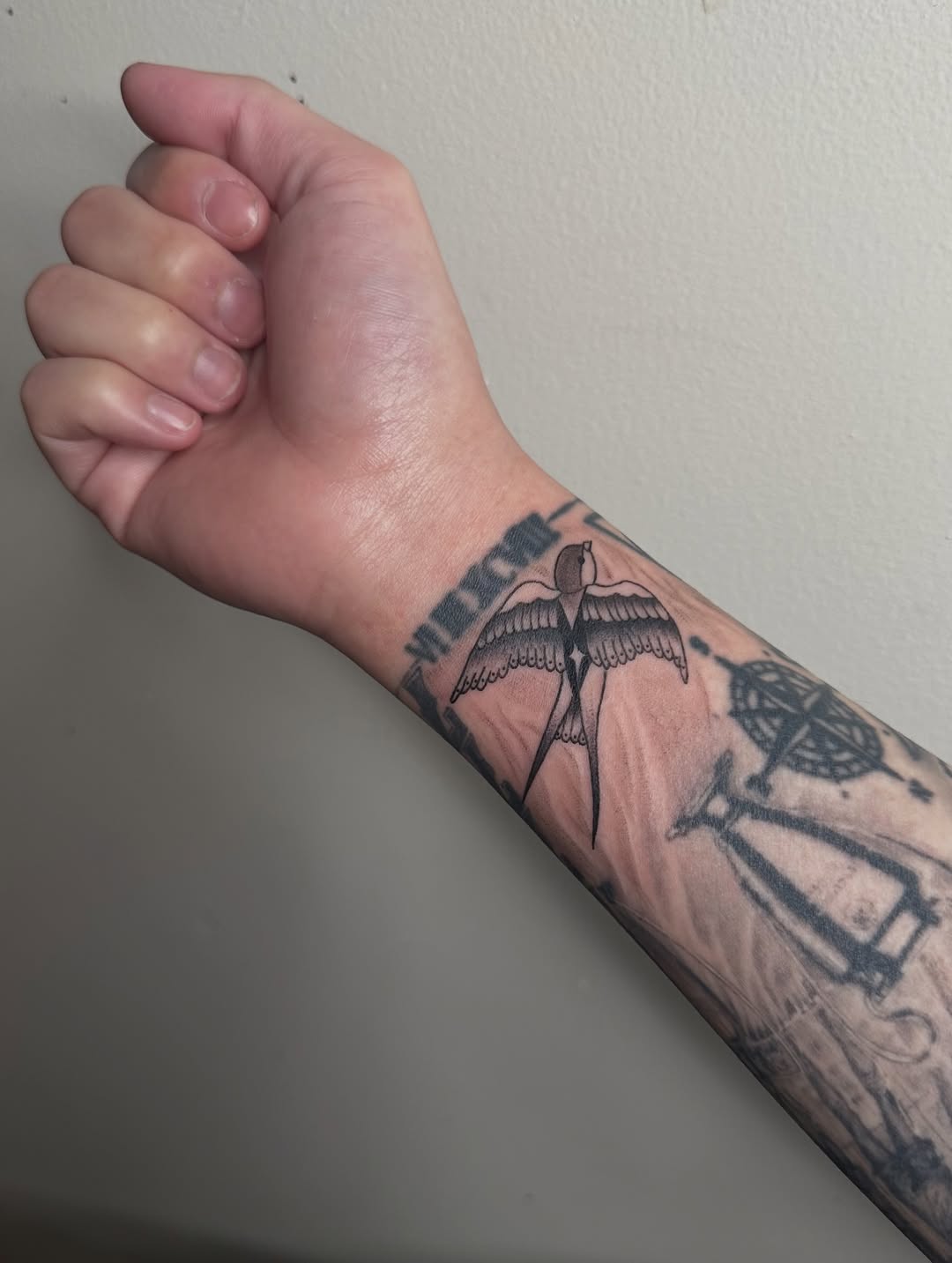 Swallow bird and roman numerals fine line tattoo on the forearm by Cherry🥀