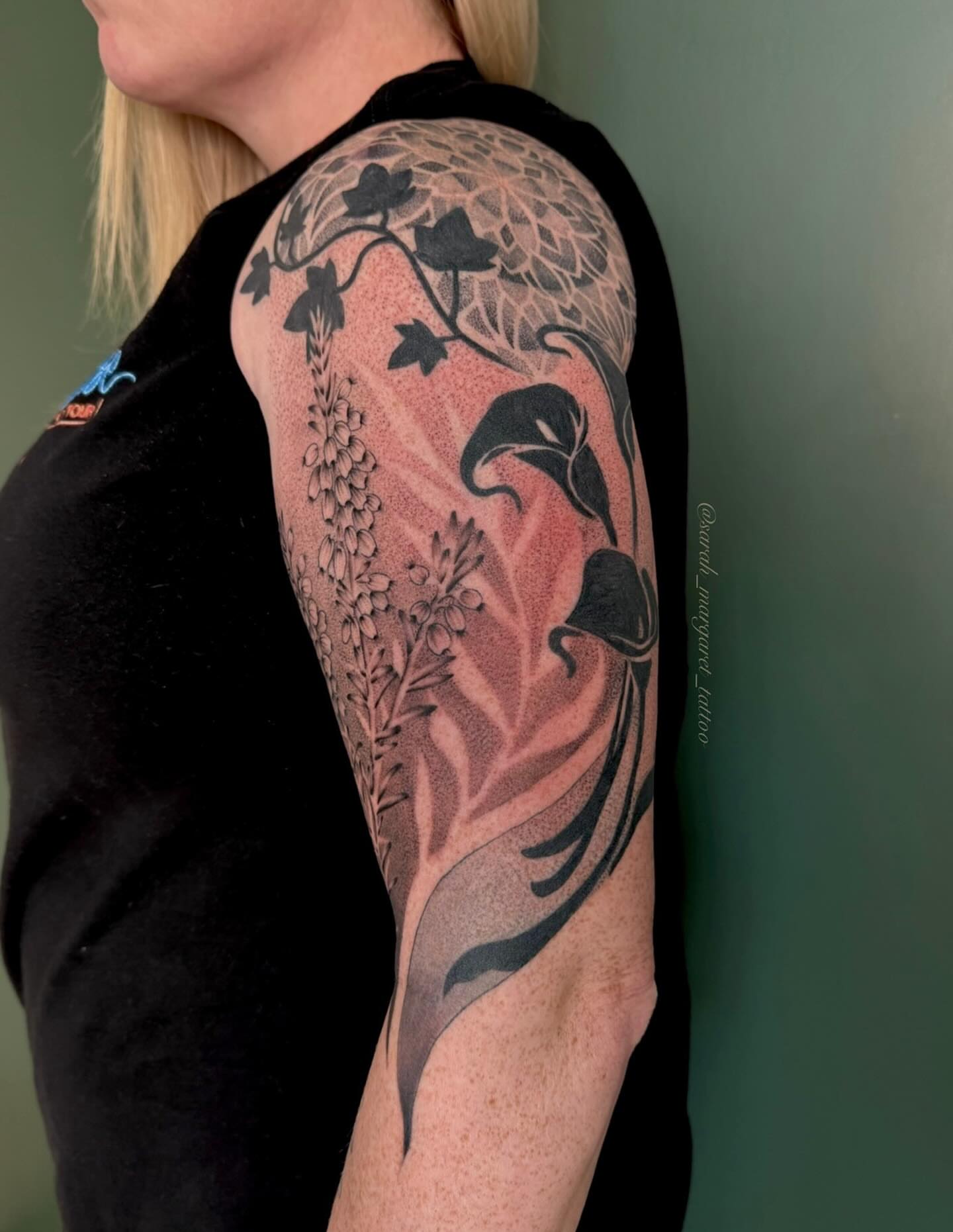 Floral arrangement dotwork tattoo on the upper arm by Sarah Margaret