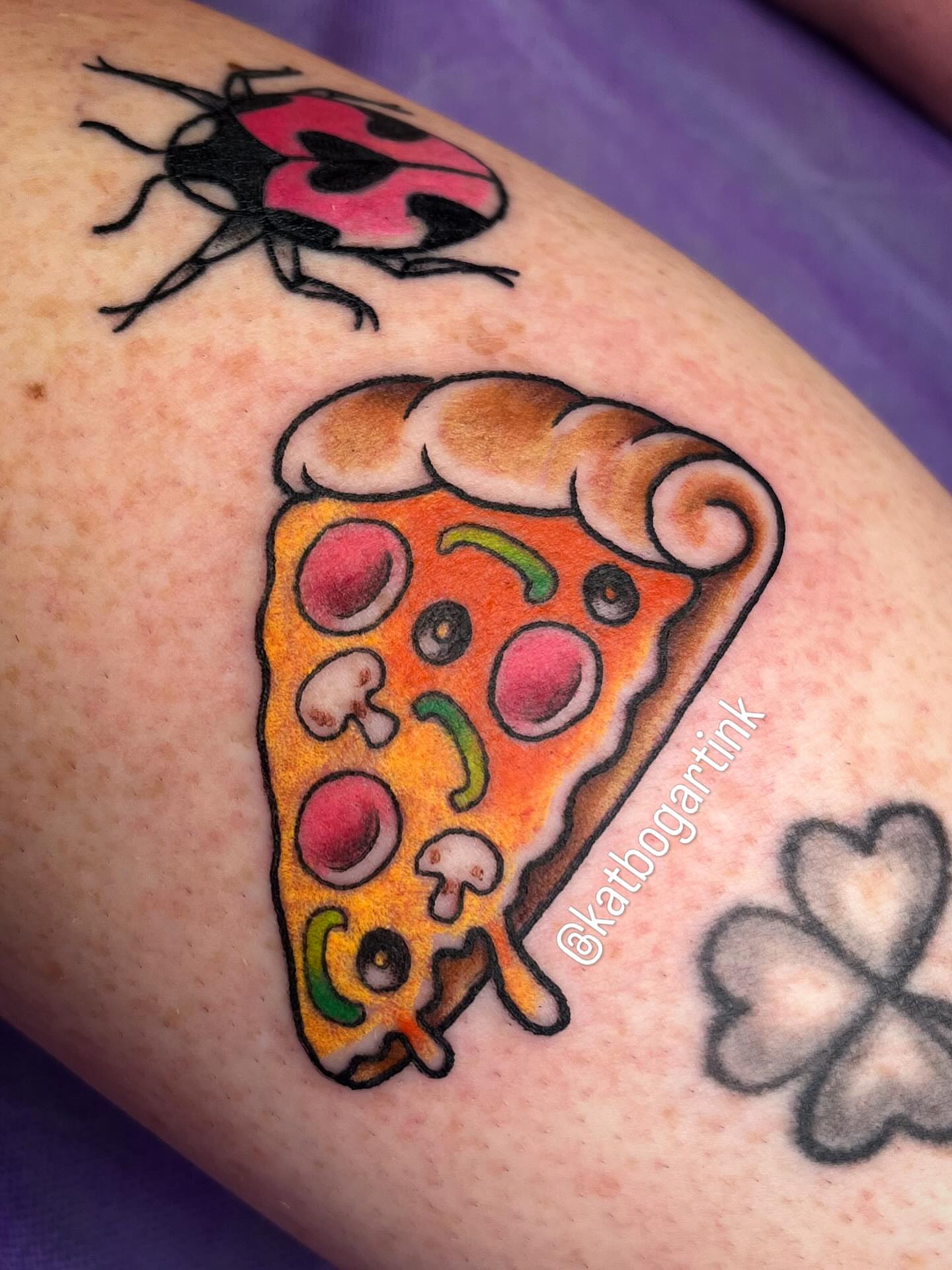Pizza slice realism tattoo on the forearm by Kat (Scout) Bogart