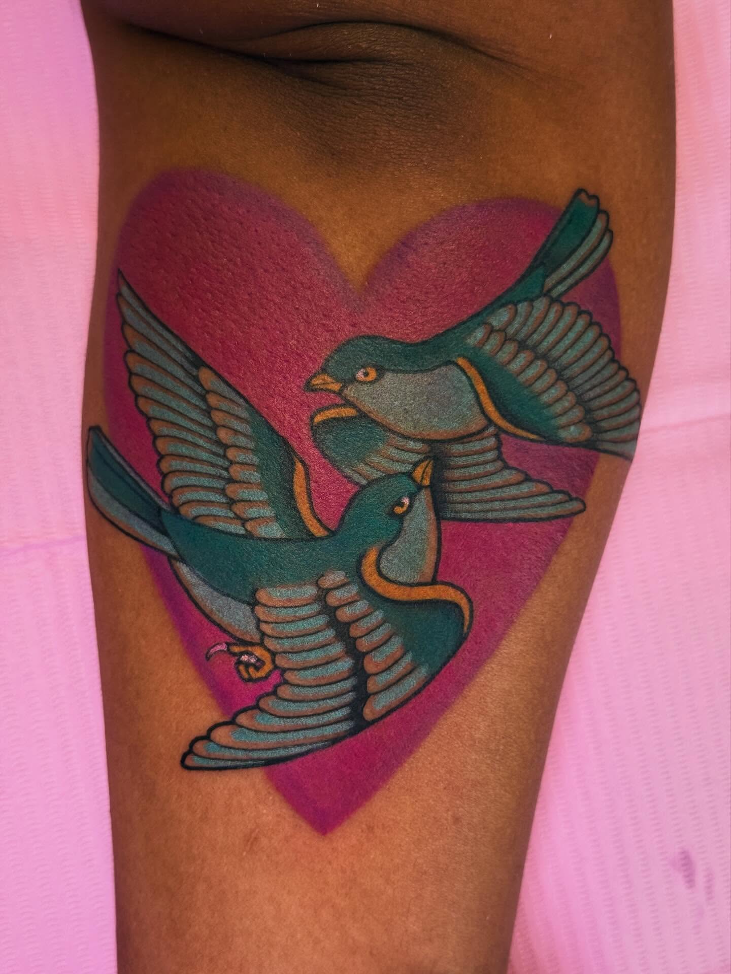 Birds and heart American traditional tattoo on the thigh by Cassie O'Neal DeBord