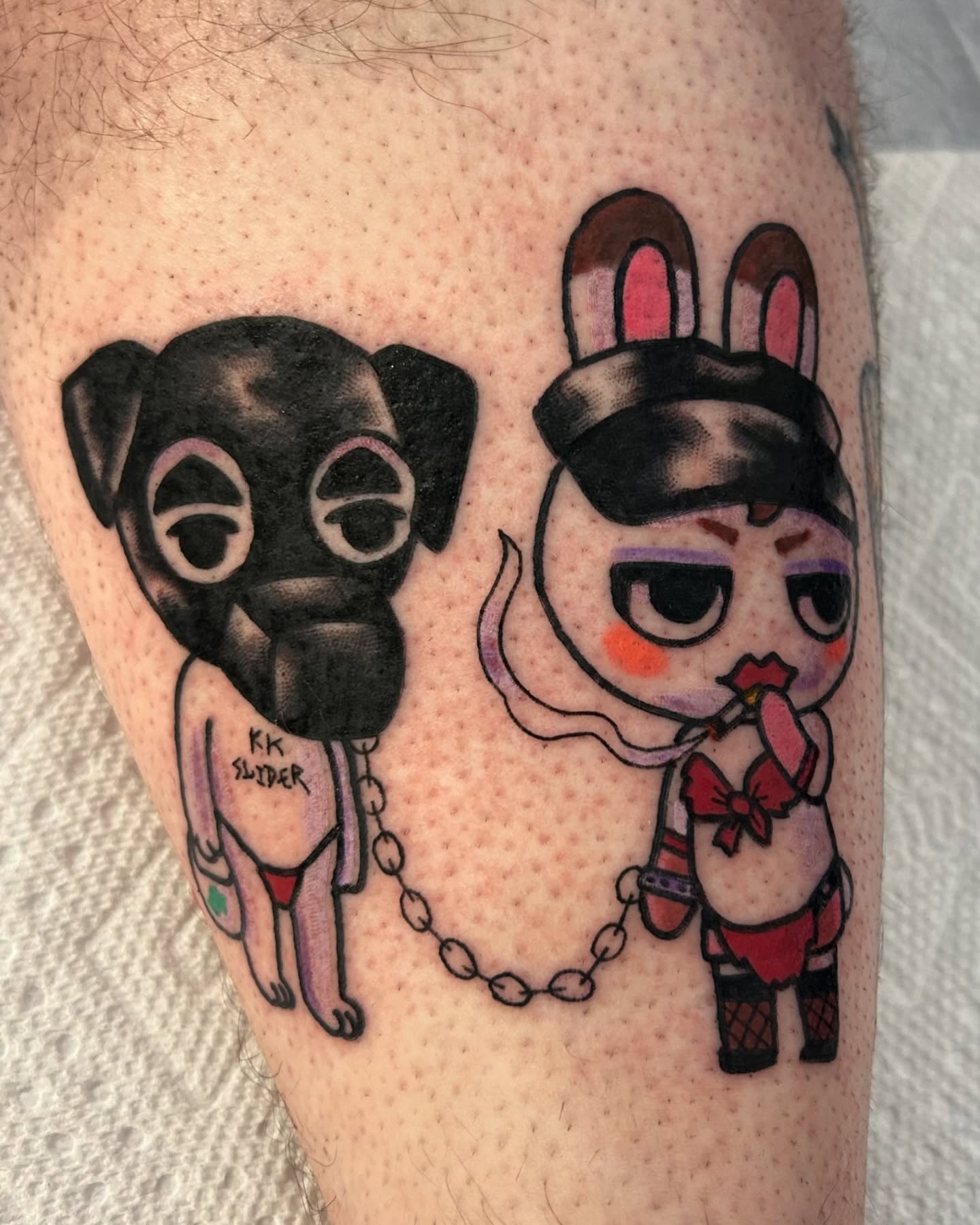 Dog and rabbit anime tattoo on the forearm by Ollie