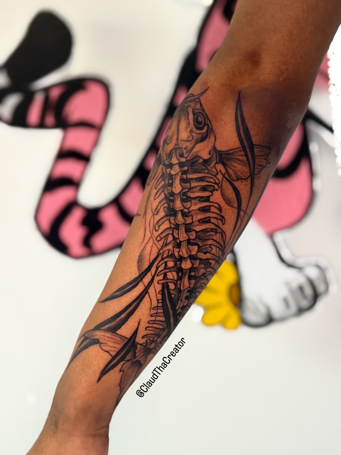 Fish skeleton black and grey tattoo on the forearm by claud, Atlanta, Georgia