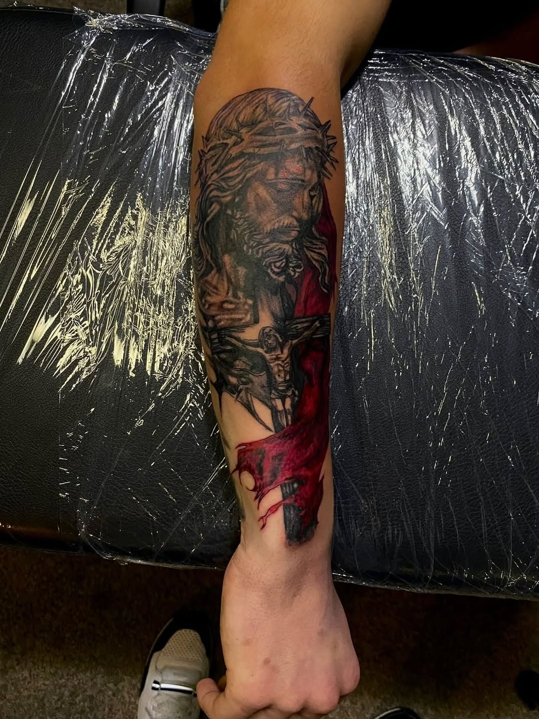 Jesus Christ on the cross realism tattoo on the forearm by Jelani